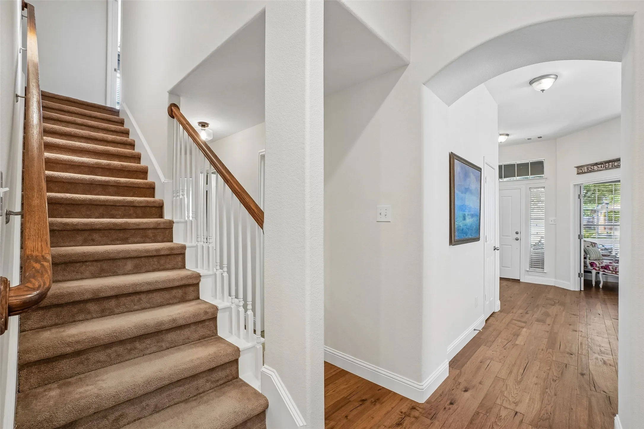 A view of the entry, stairs and hallway to the bedrooms.