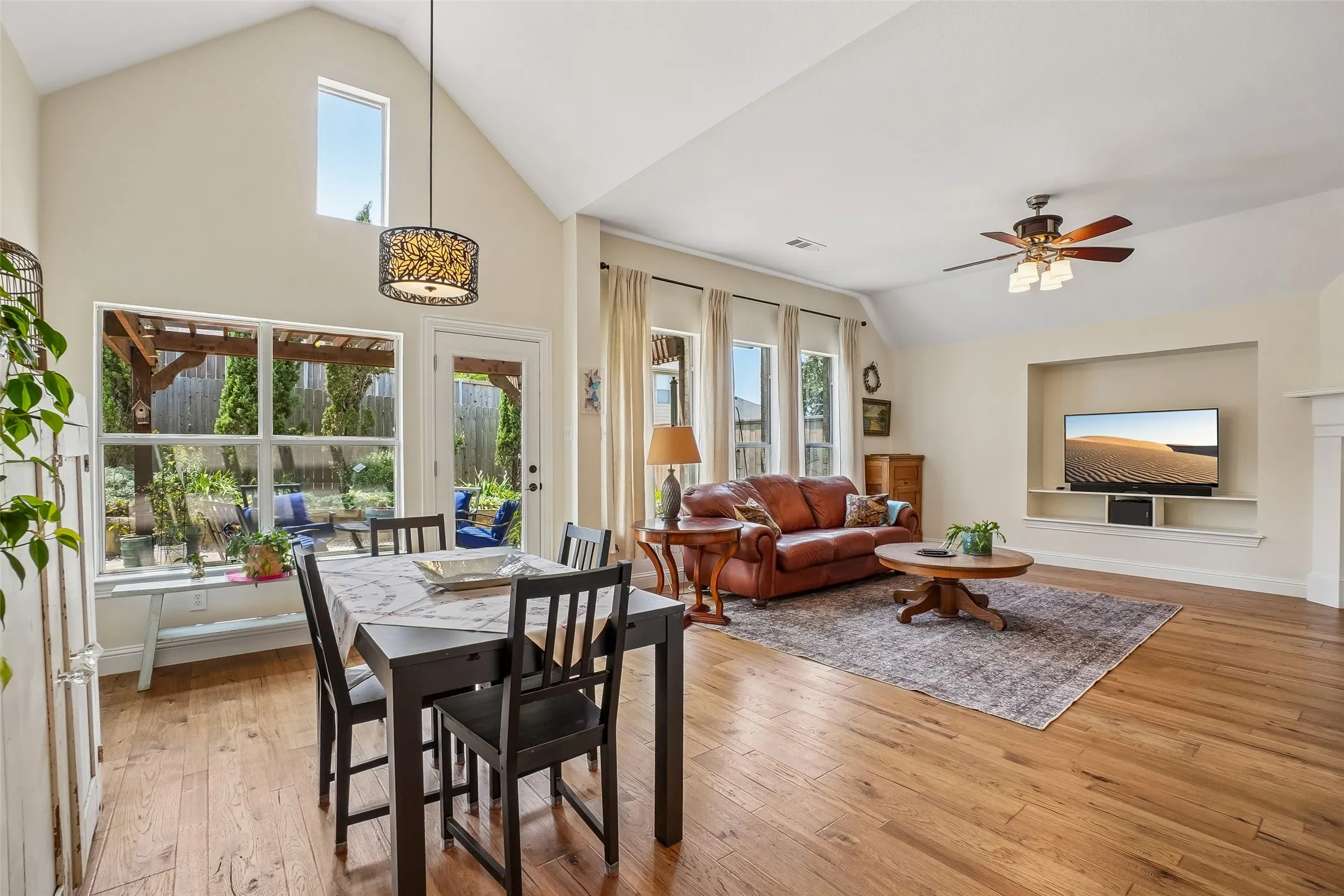 A wall of windows looks out to the covered patio.  Engineered hickory floors.