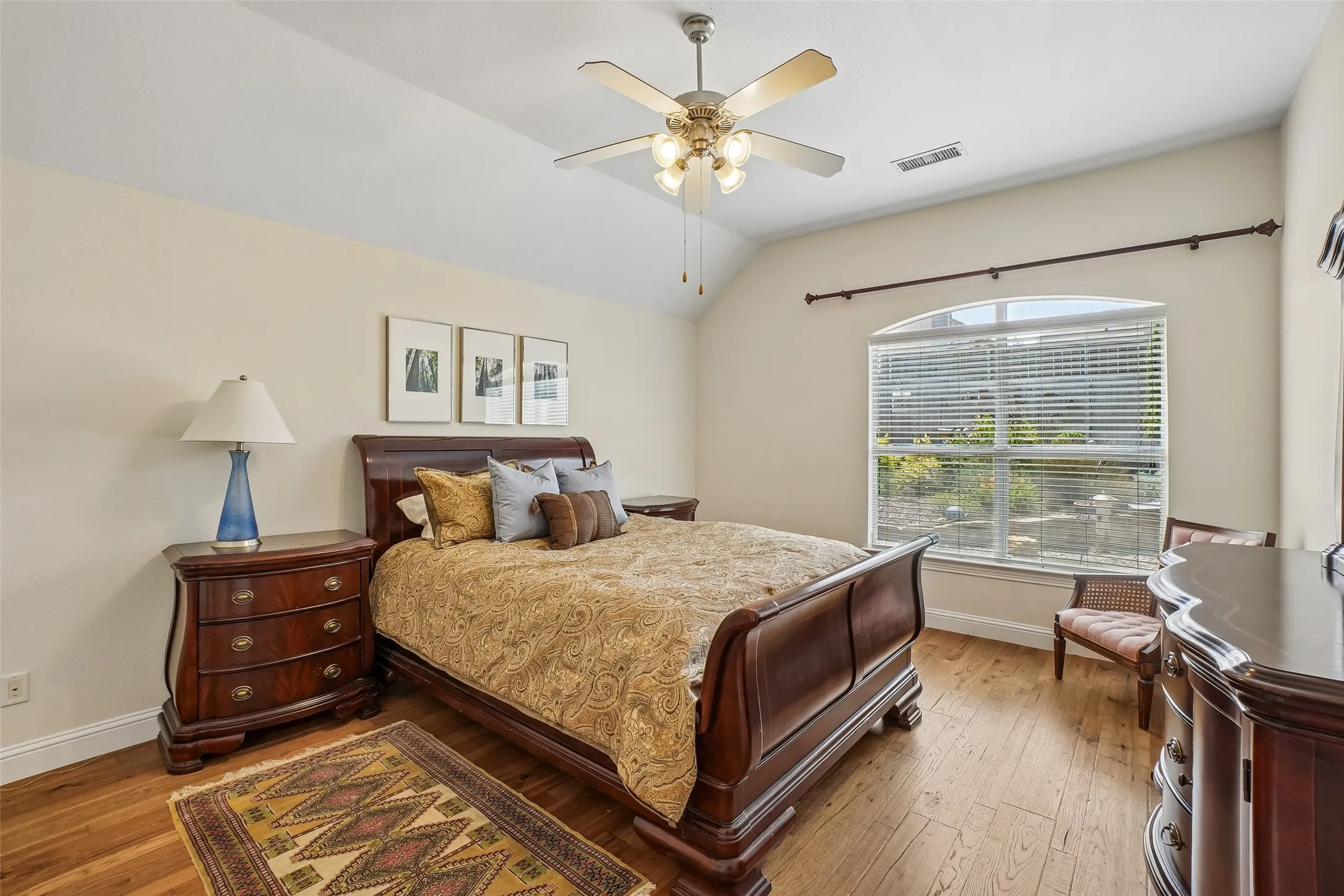 Engineered hickory wood floors, ceiling fan, and windows that look out to the landscaped backyard.