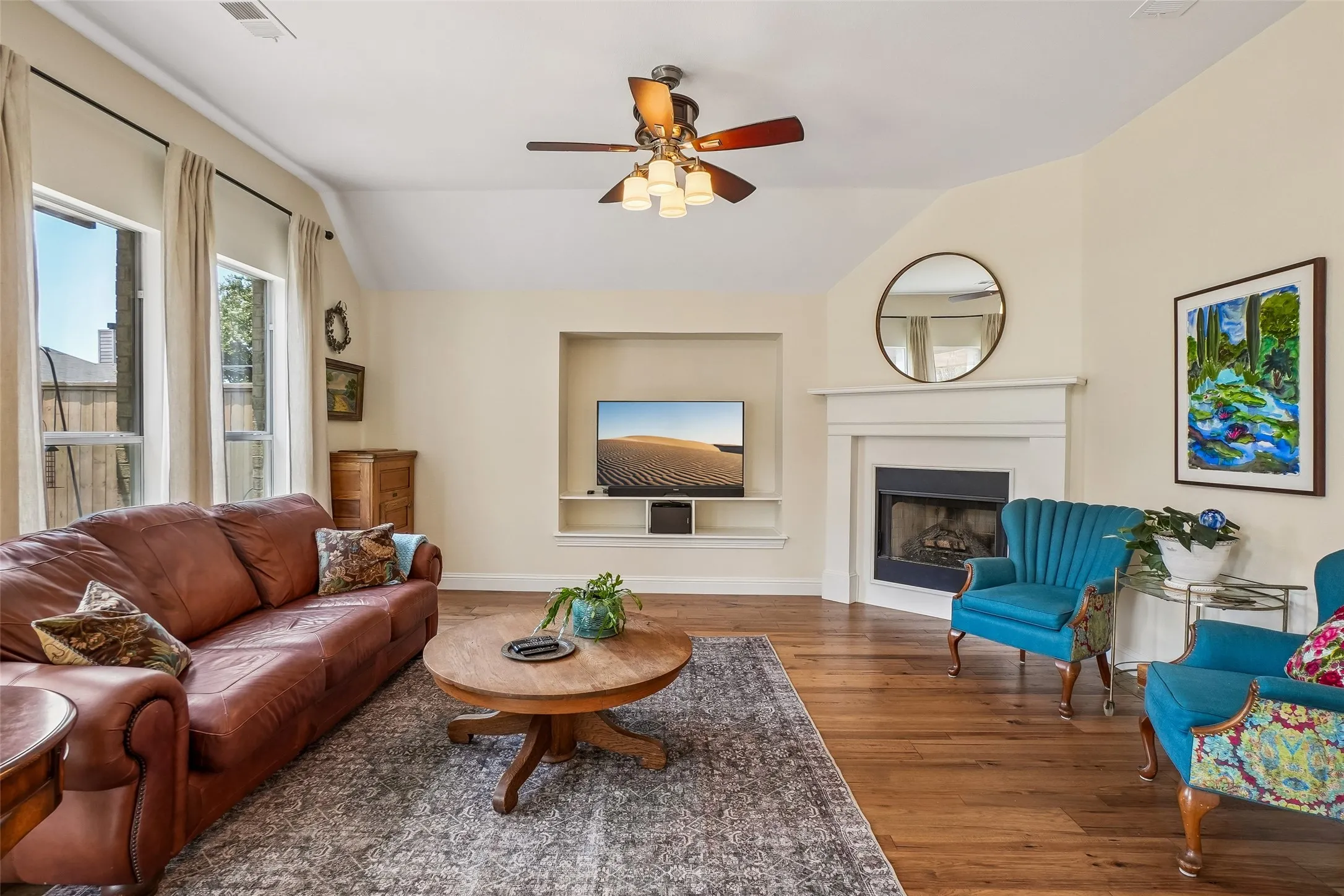 Family room with a wall of windows looking out to the landscaped back yard.