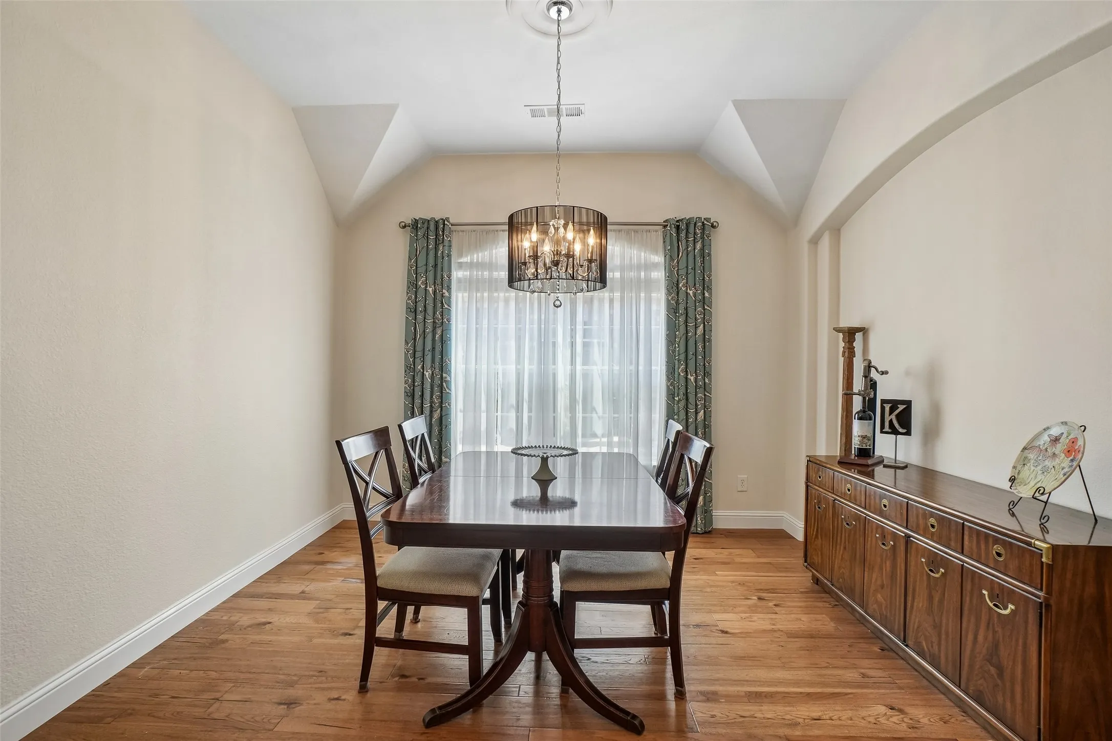 Dining area with room for a larger table and cabinet.