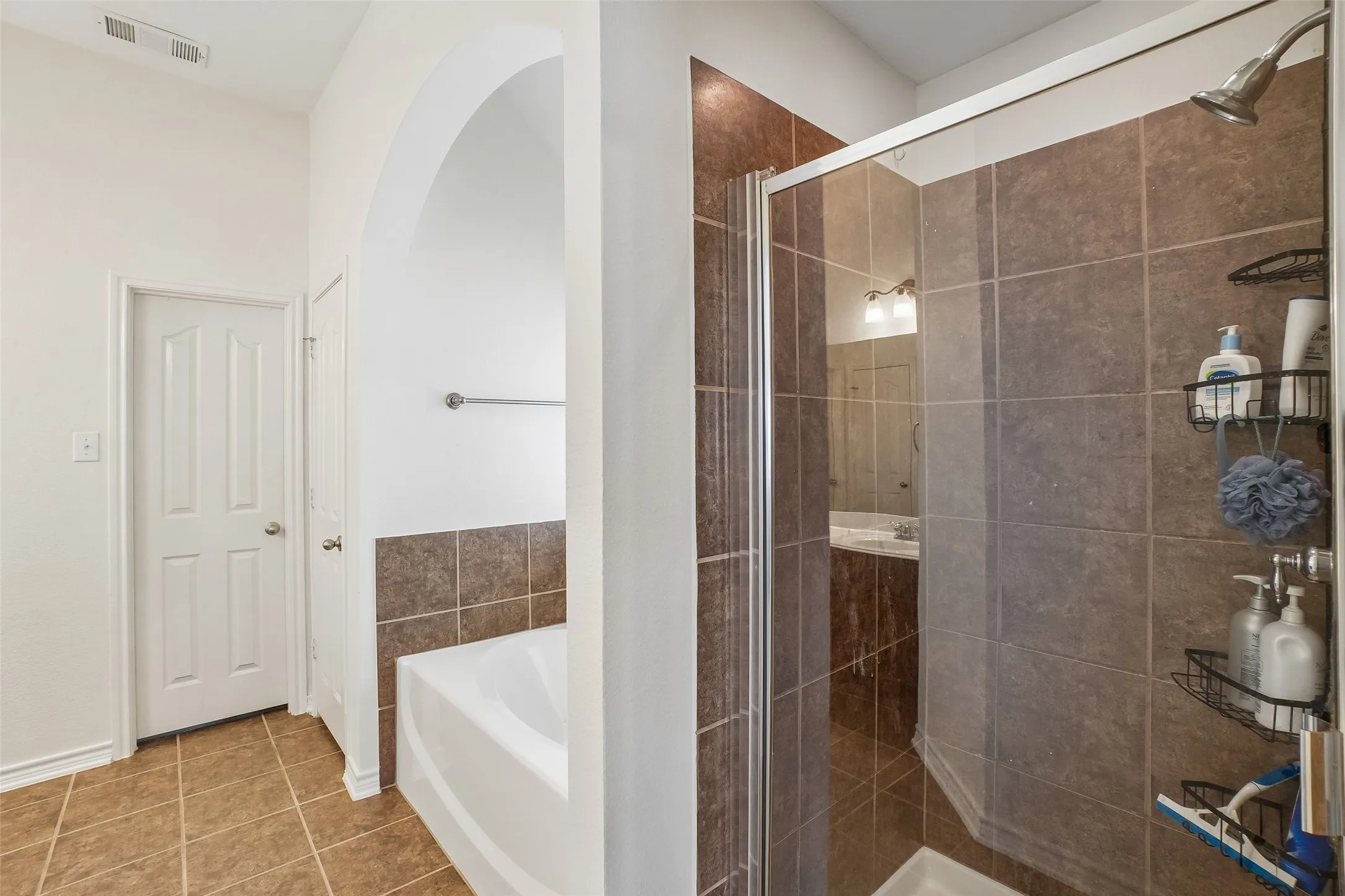 Tile floors, showers with tile, garden tub, and two sinks.