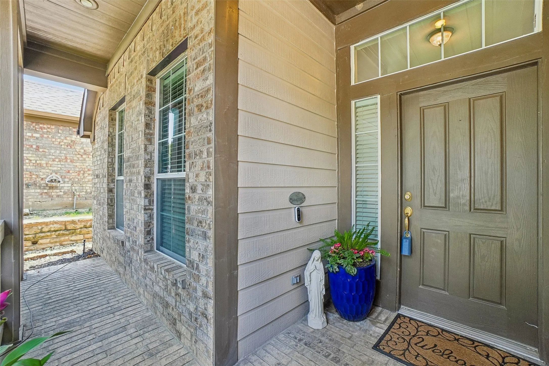 Private front porch with a brick floor.