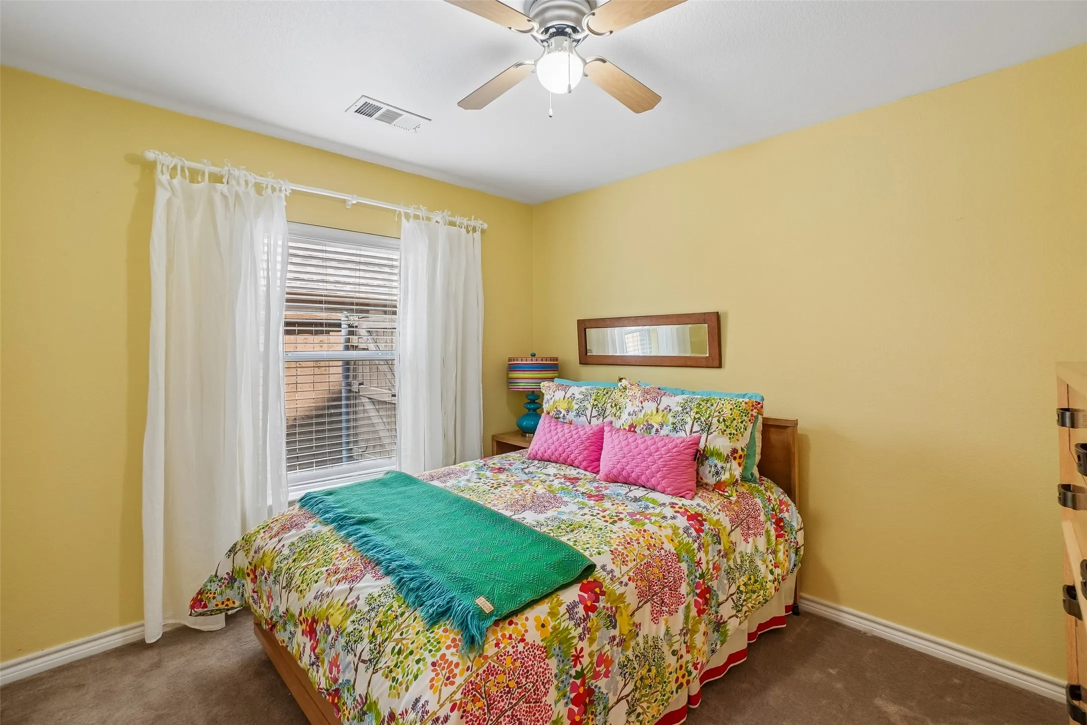 One of the bedrooms downstairs.  Carpet, ceiling fan and a closet.