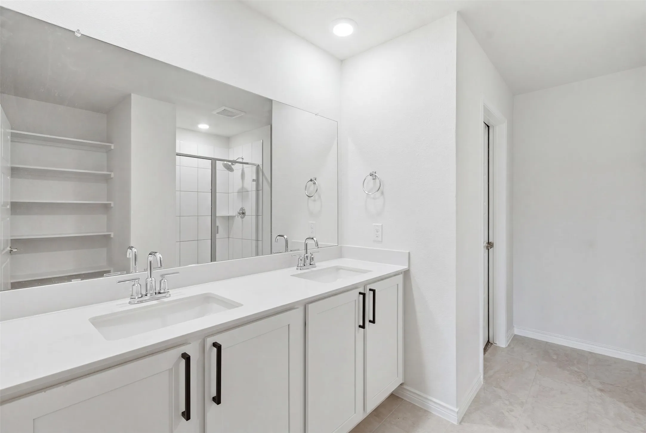 Dual vanity featuring white countertops, undermount sinks, and matte black hardware