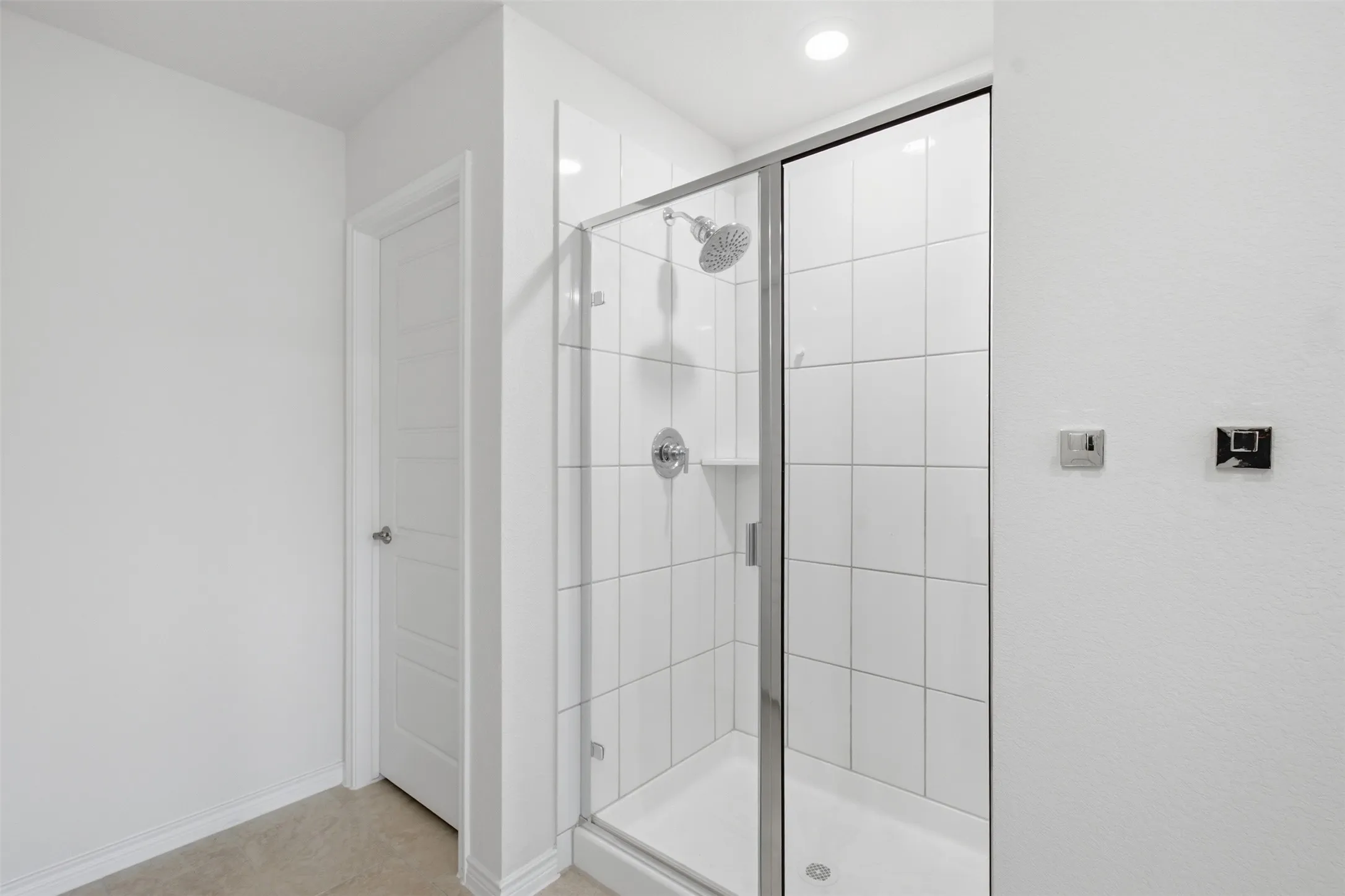 Shower enclosure featuring clear glass panels and chrome hardware