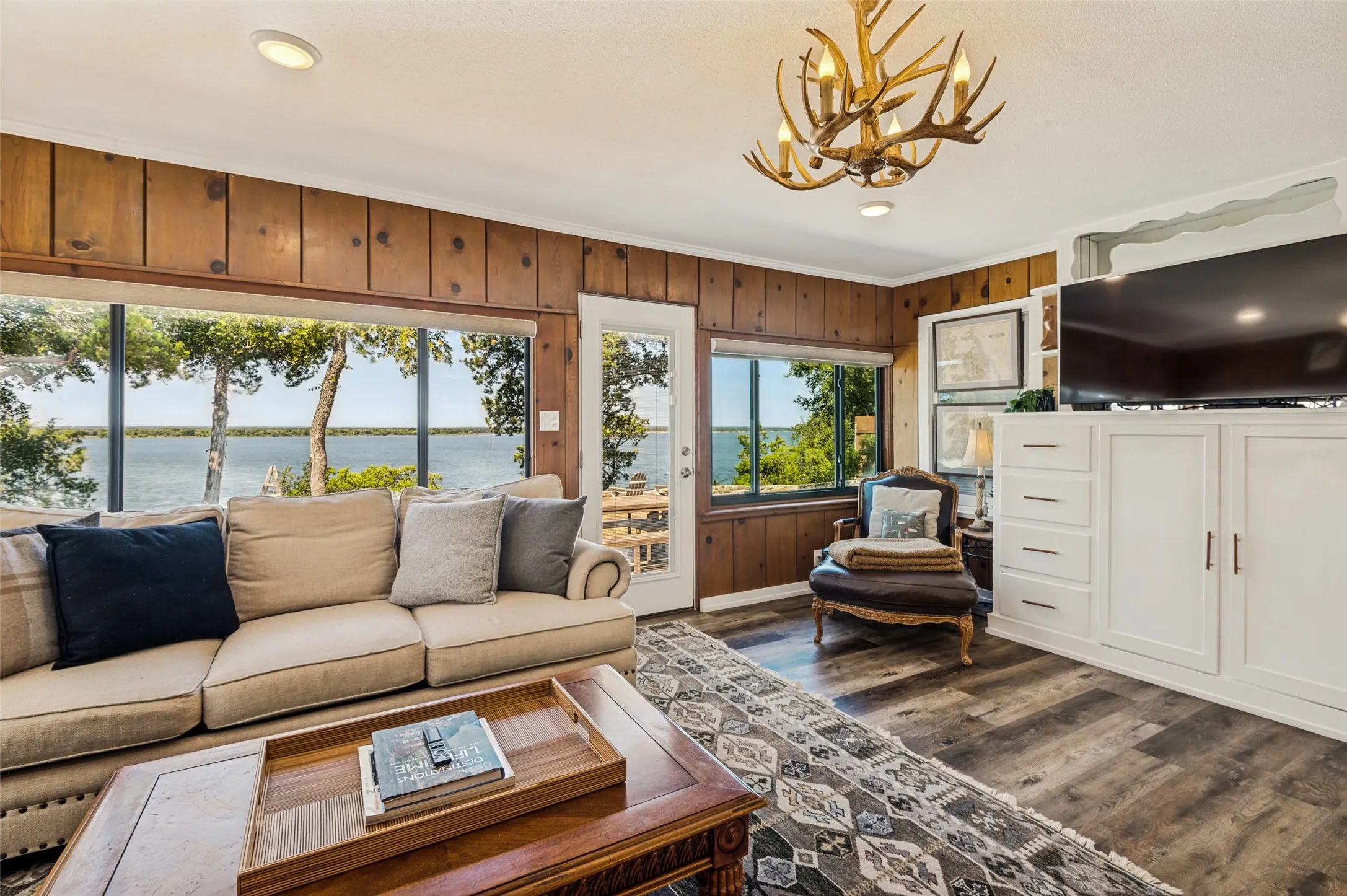 Built-ins with TV, recessed lighting, window shades, door to back yard and lake access.