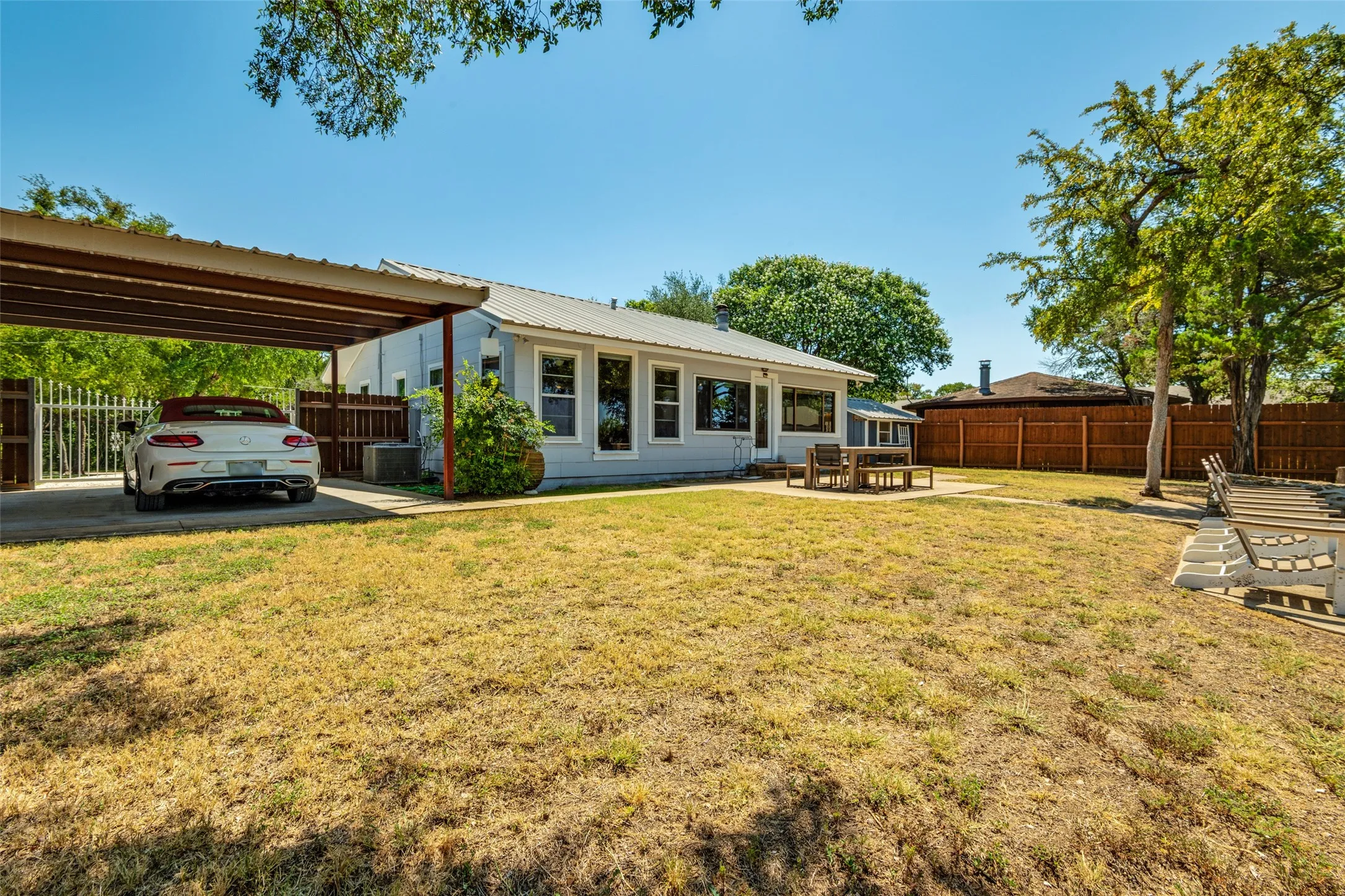 Gated covered carport can also be used as extra covered entertaining area.