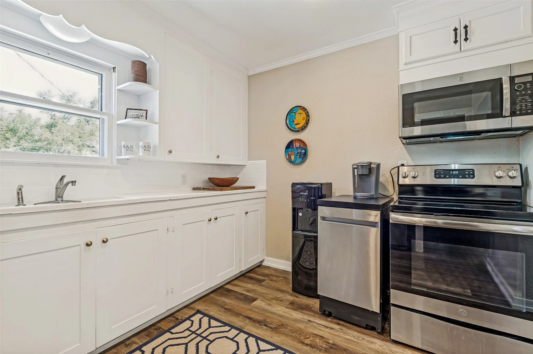 All stainless steel appliances included with purchase... range, dishwasher, microwave, full-size refrigerator.