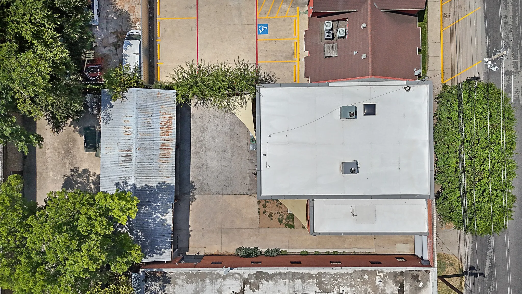 Aerial perspective showcasing multiple commercial buildings with flat and sloped rooflines