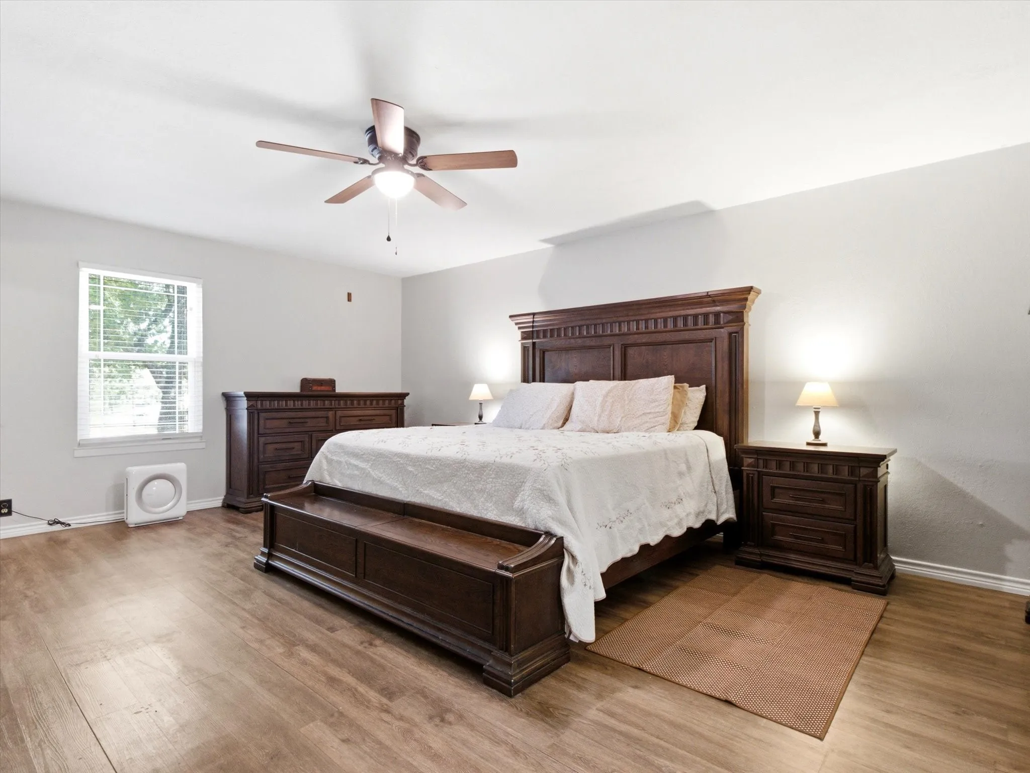 Wood-finish flooring with a ceiling fan overhead
