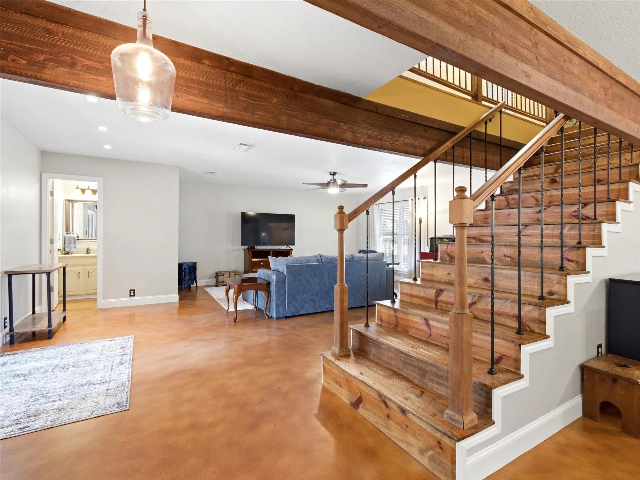 Crafted wooden staircase with wrought iron balusters and a rich wood-finish handrail