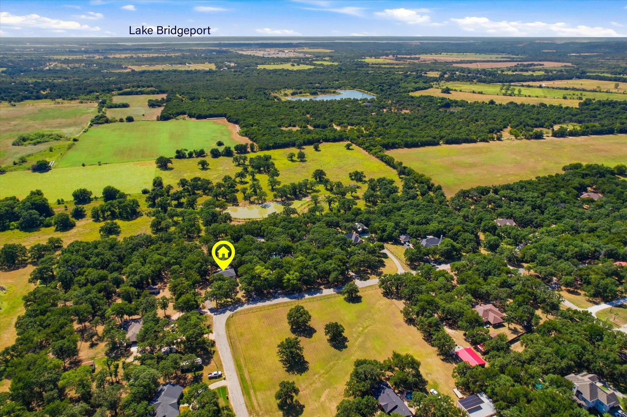 Expansive aerial perspective showcasing a property surrounded by mature trees