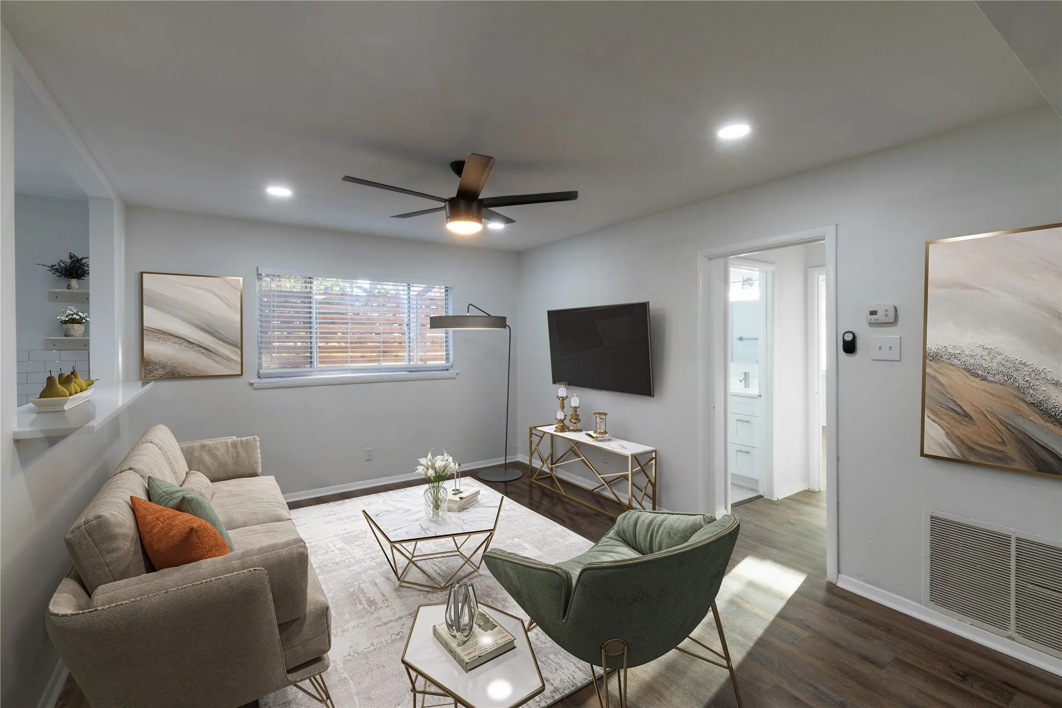 Bright living area featuring recessed lighting, a ceiling fan, and wood-finish flooring