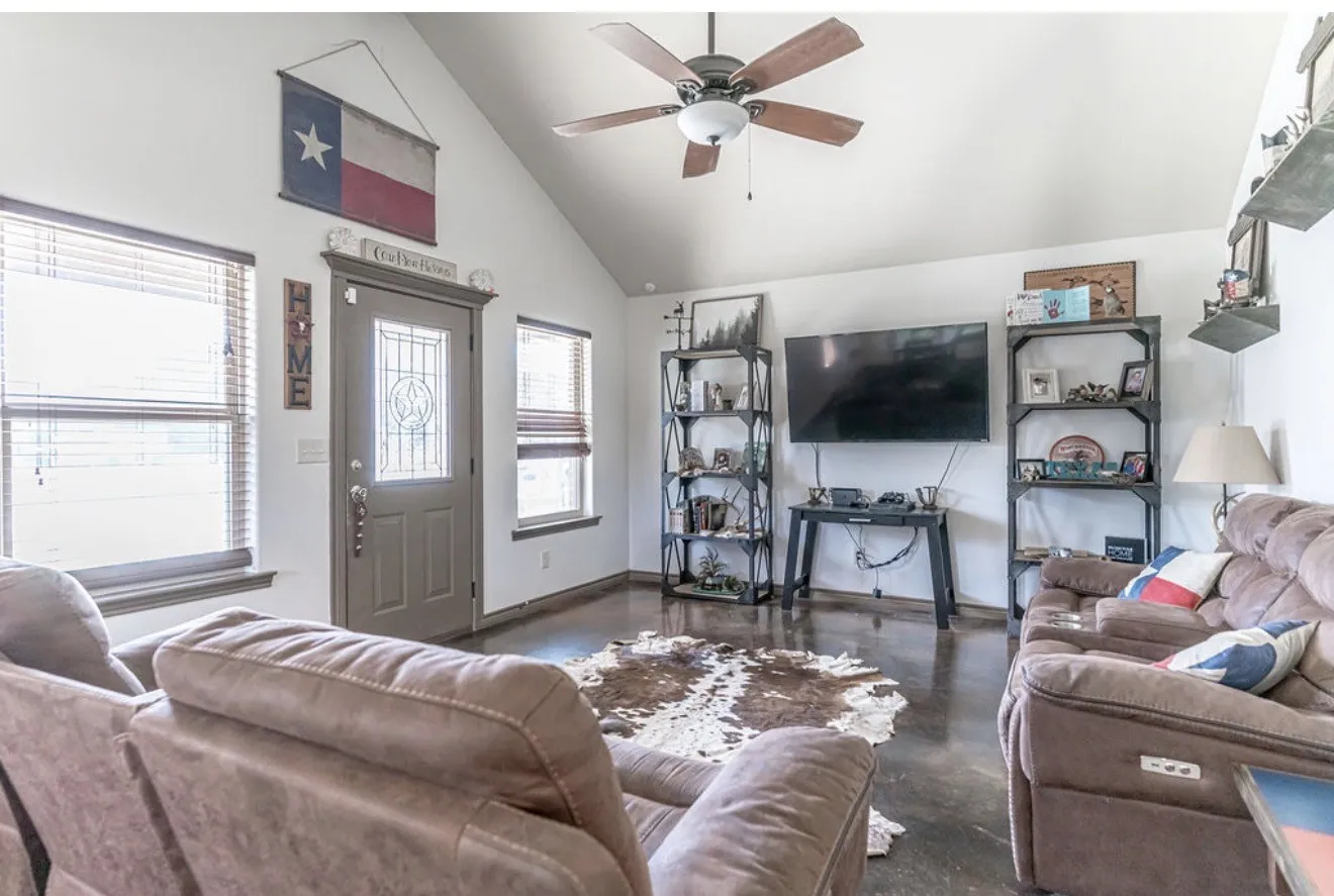 Vaulted ceiling featuring a ceiling fan with light fixture