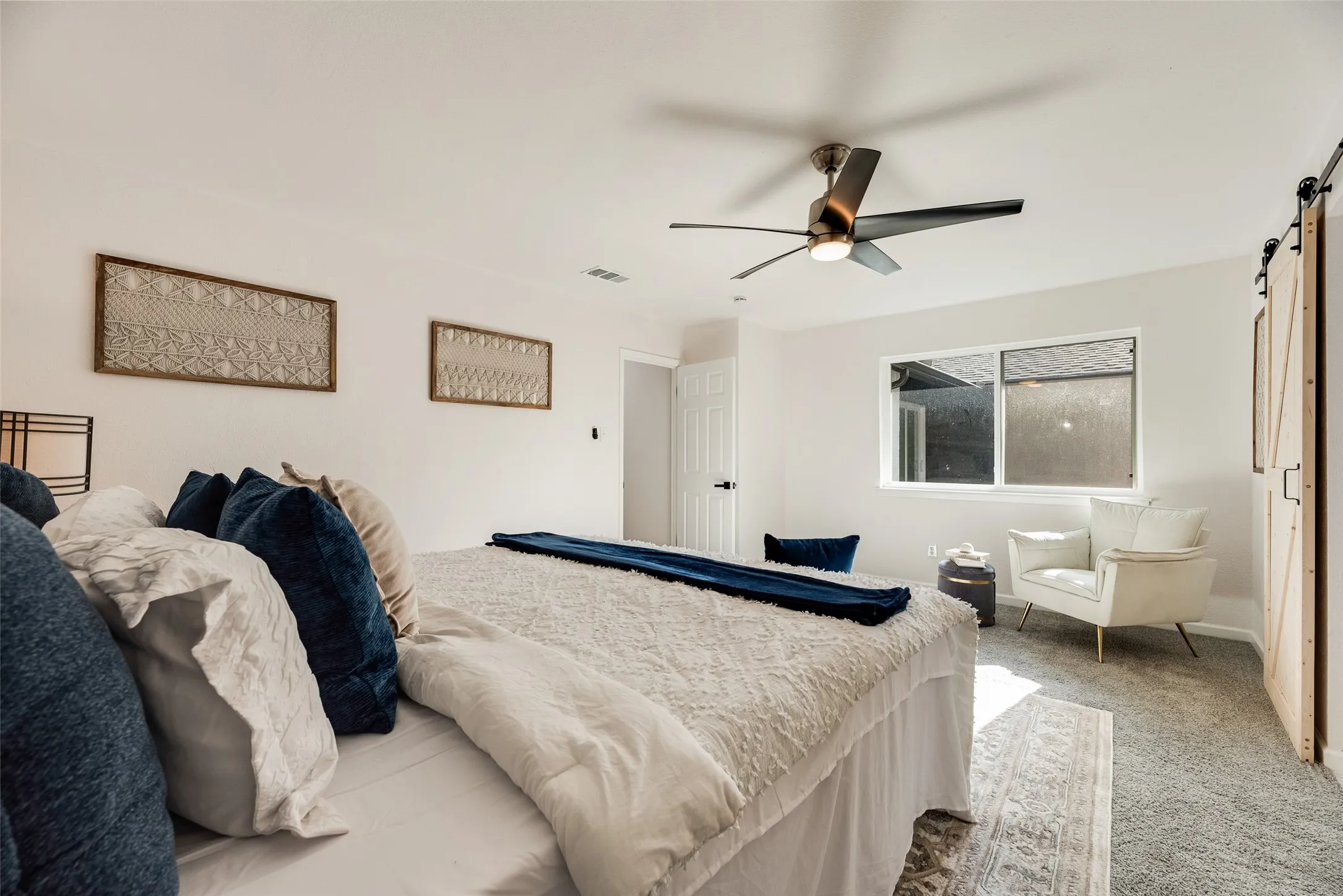 Spacious interior with neutral walls and light gray carpeting