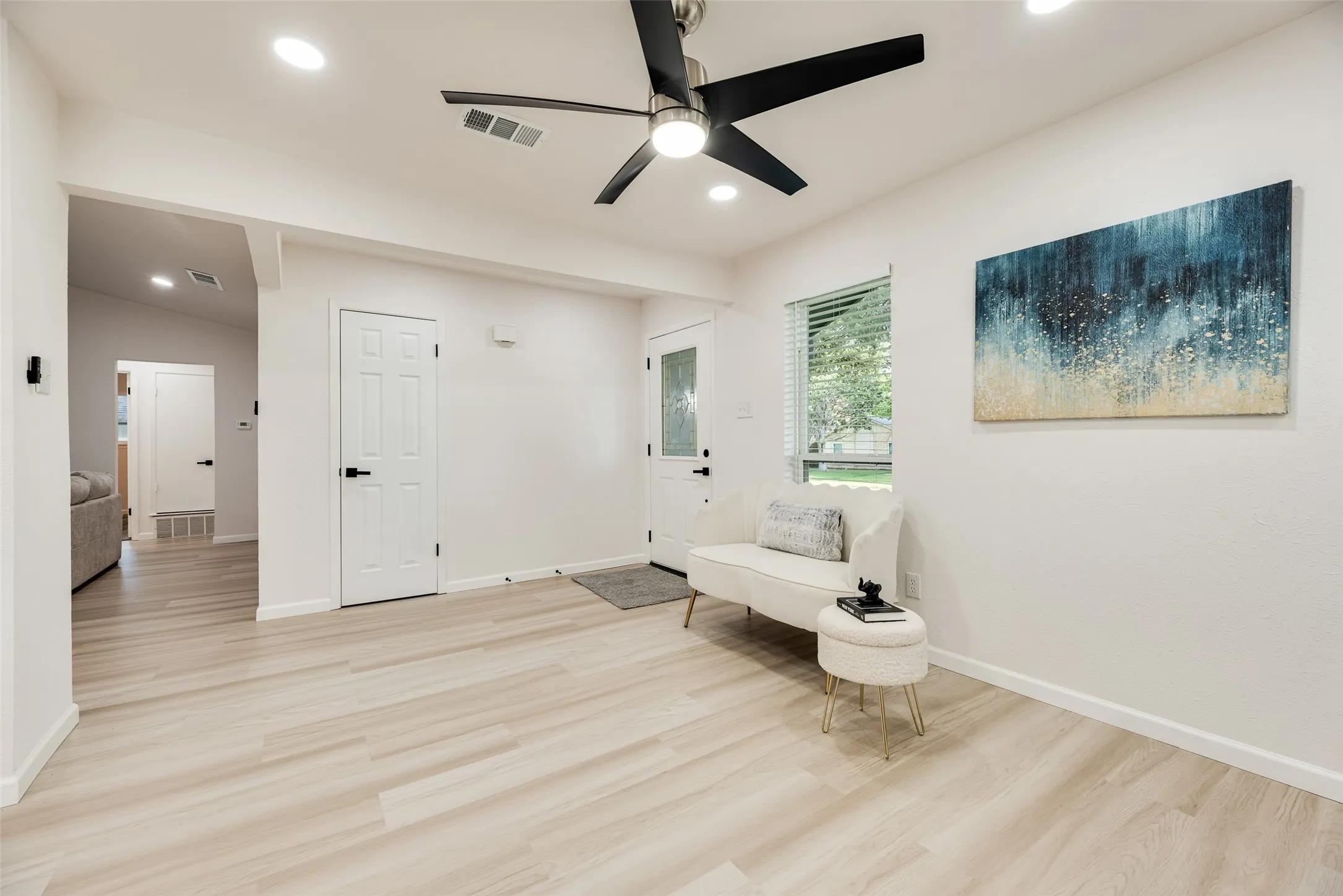 Bright interior space featuring light wood-finish flooring