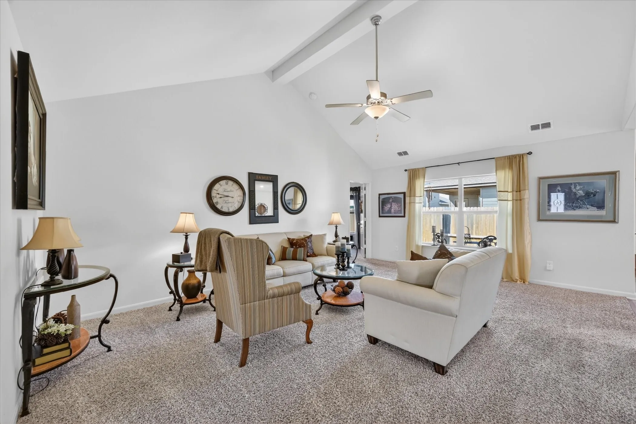 Vaulted ceiling with exposed beam and ceiling fan