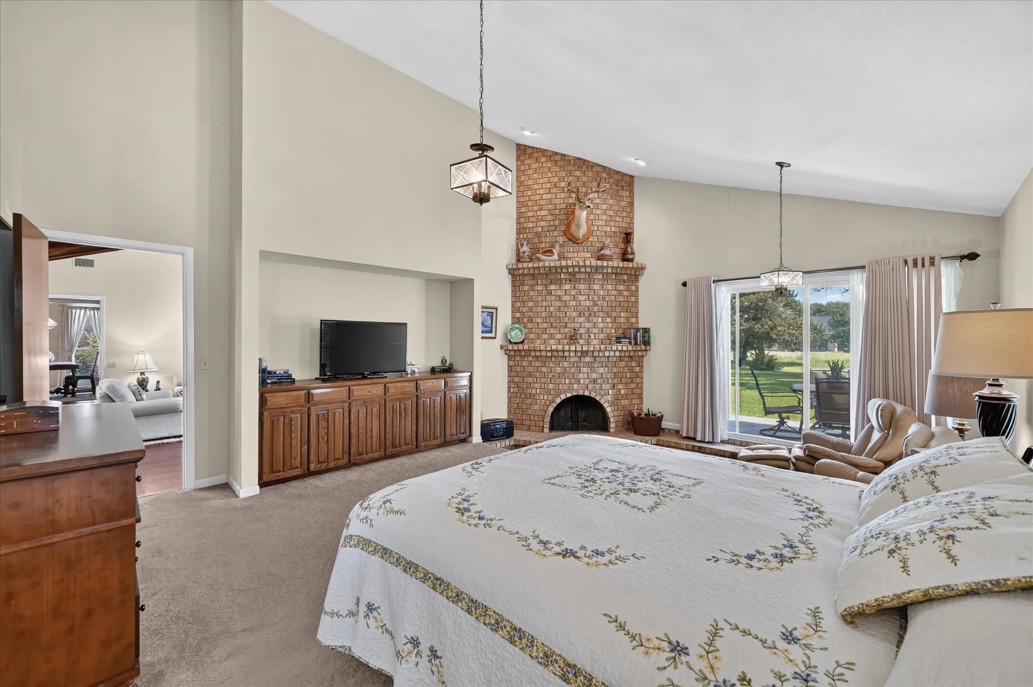 Primary bedroom with built-in's, woodburning fireplace, and sitting area!