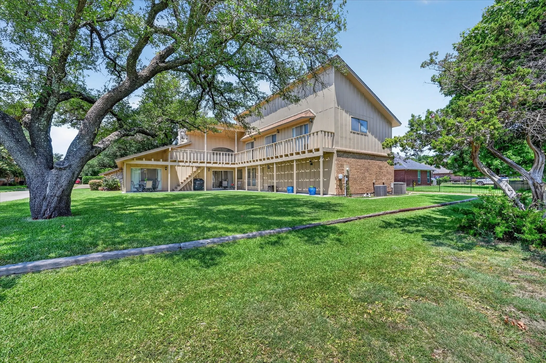 Huge backyard with covered patio & deck!  Very old Oak Tree!