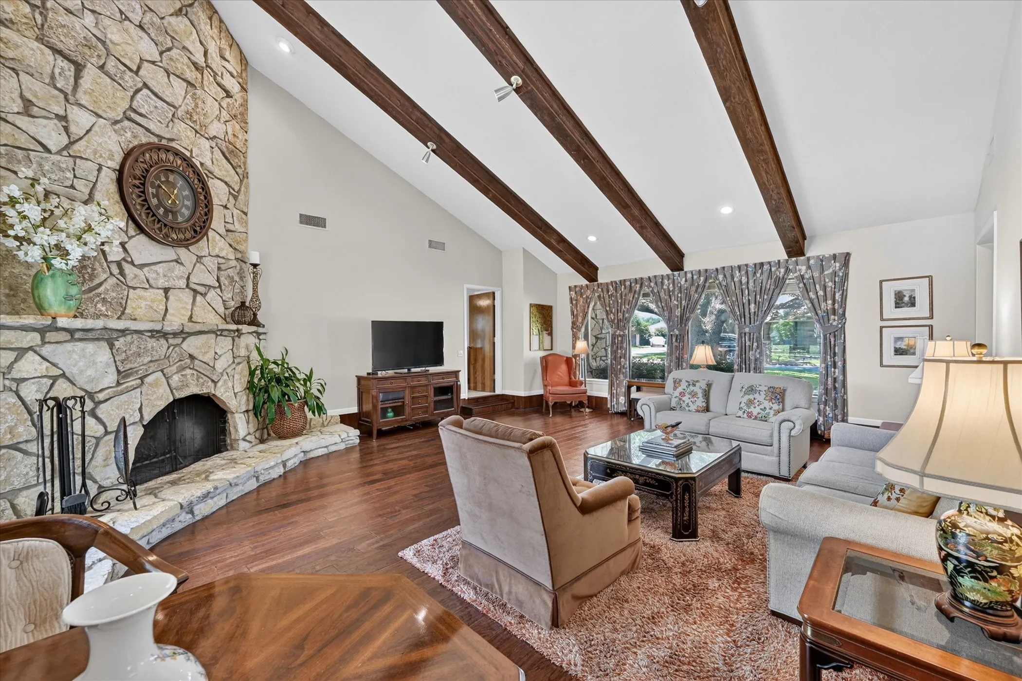 Awesome living room with large windows on the front.  Vaulted ceilings with beams! Fresh paint!