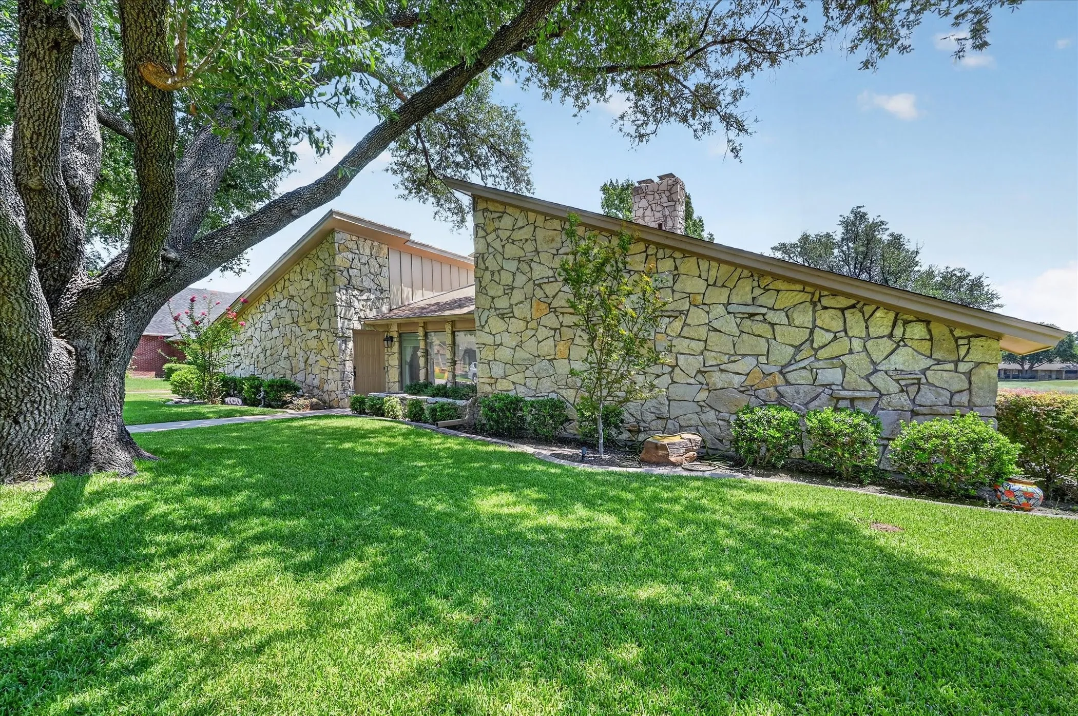 Another view of this great home with a well maintained yard.  Huge Old Oak Tree!