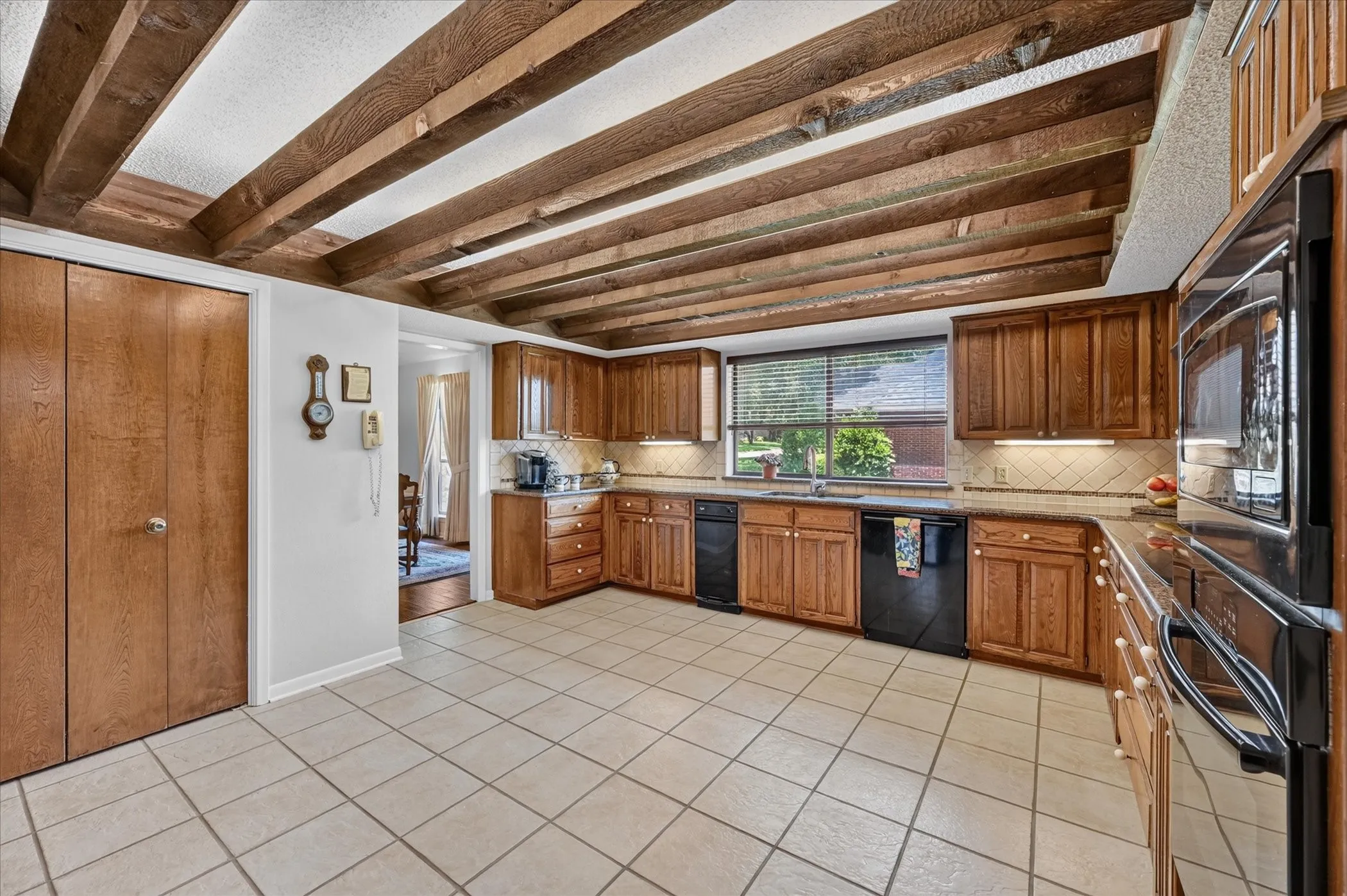 Spacious updated kitchen with granite countertops, tile backsplash, built in appliances, under counter lighting. Large Pantry.  Plenty of room for an island!