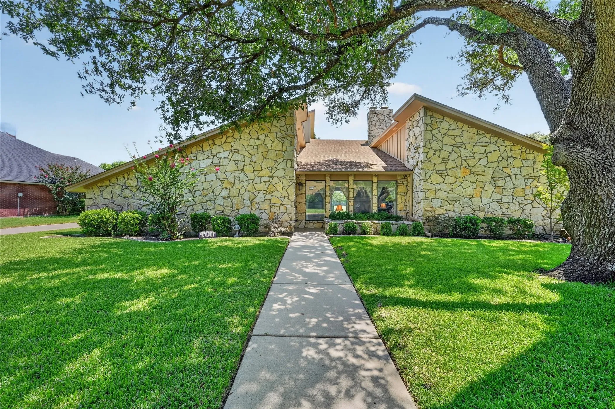 ONE OWNER HOME ON .25 ACRE LOT! Fabulous mid-century custom-built stone home with lush landscaping, and huge old oak tree! Backs to a greenbelt!Well maintained home on a fabulous tree lined street!