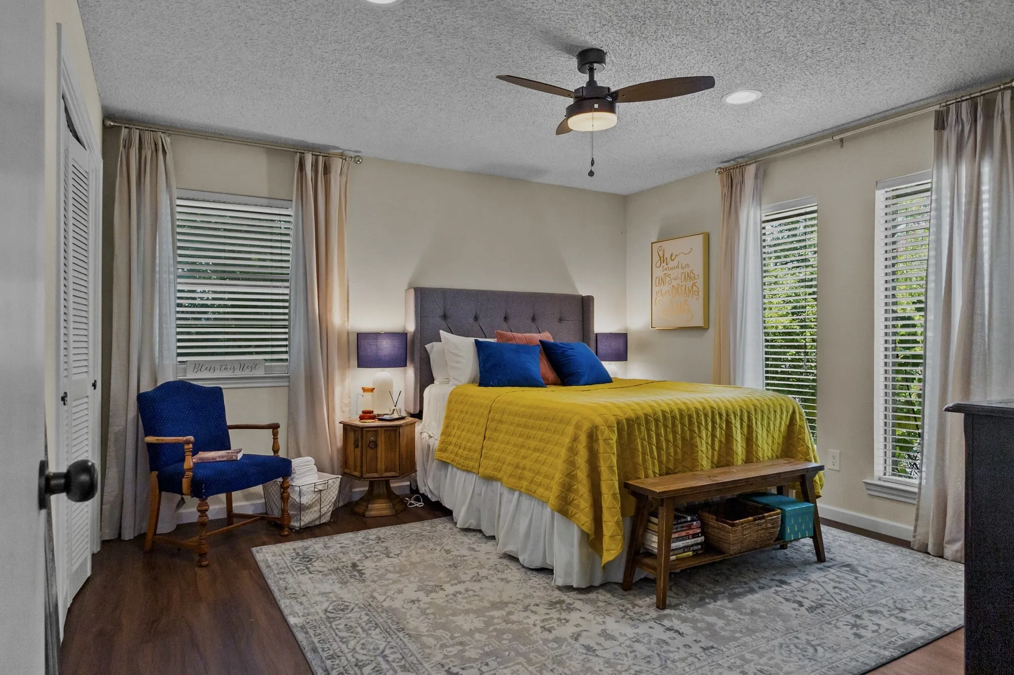 Wood-finish flooring with a ceiling fan and recessed lighting
