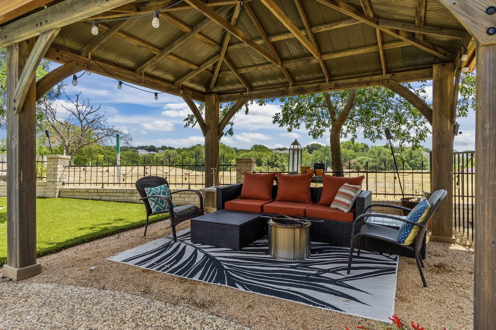 Expansive outdoor gazebo with a corrugated metal roof and exposed wood beams