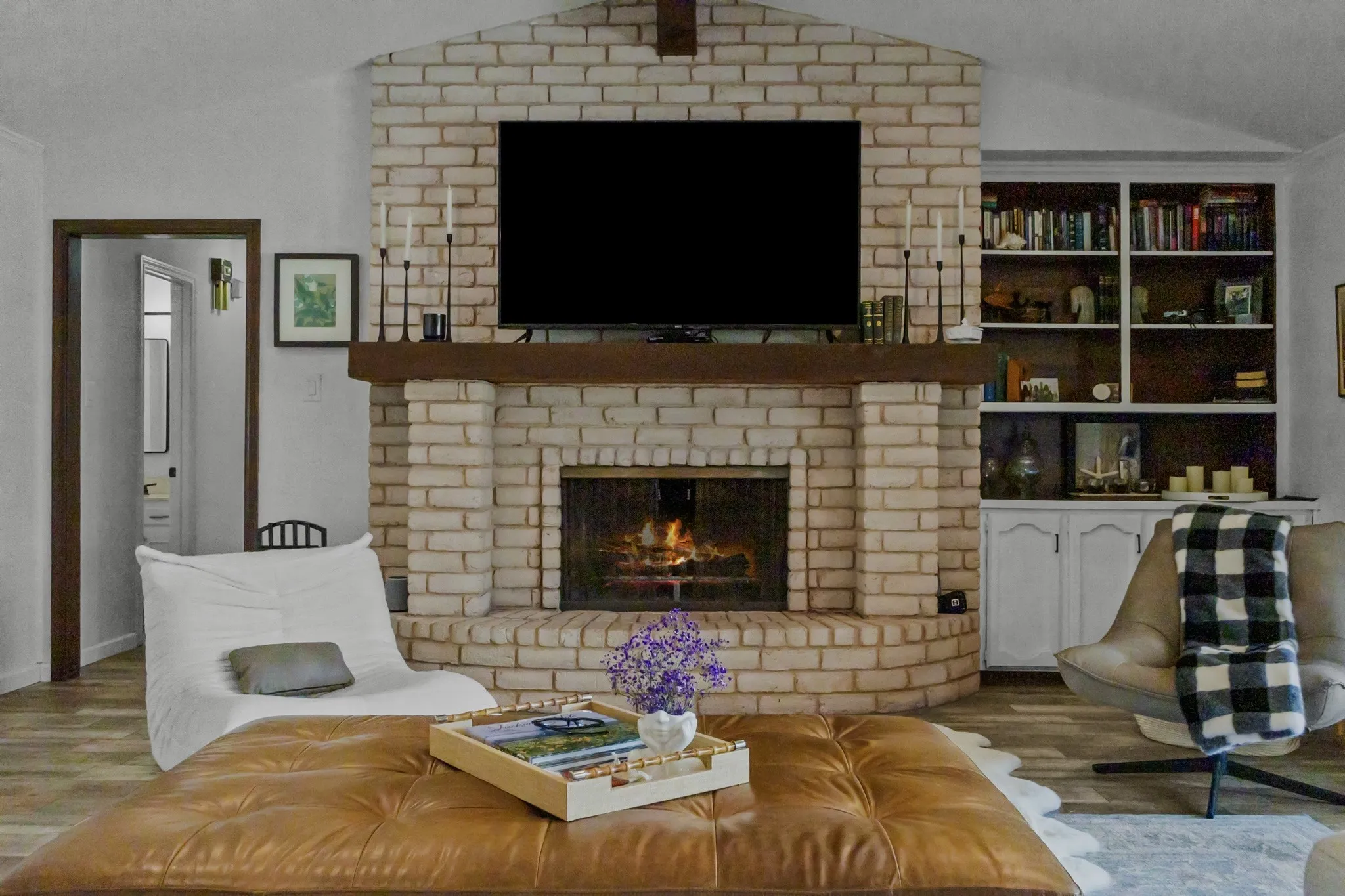 Brick fireplace with a substantial wood mantel
