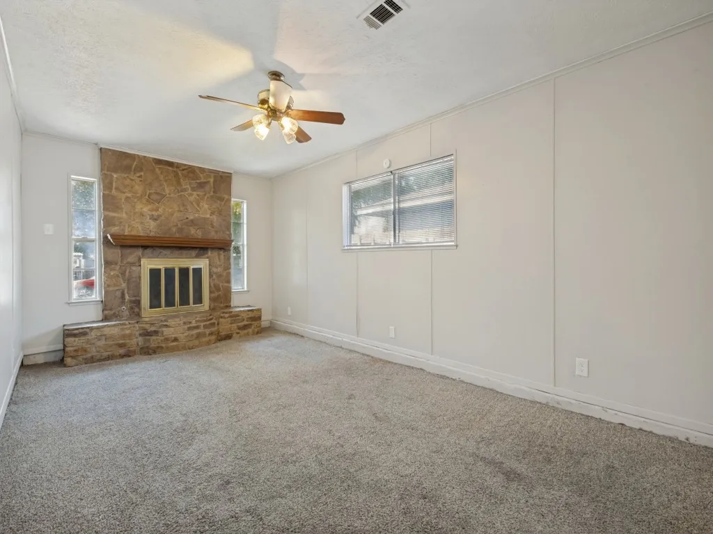 Second living area with stone-clad fireplace and closet that can be used as a 4th primary bedroom