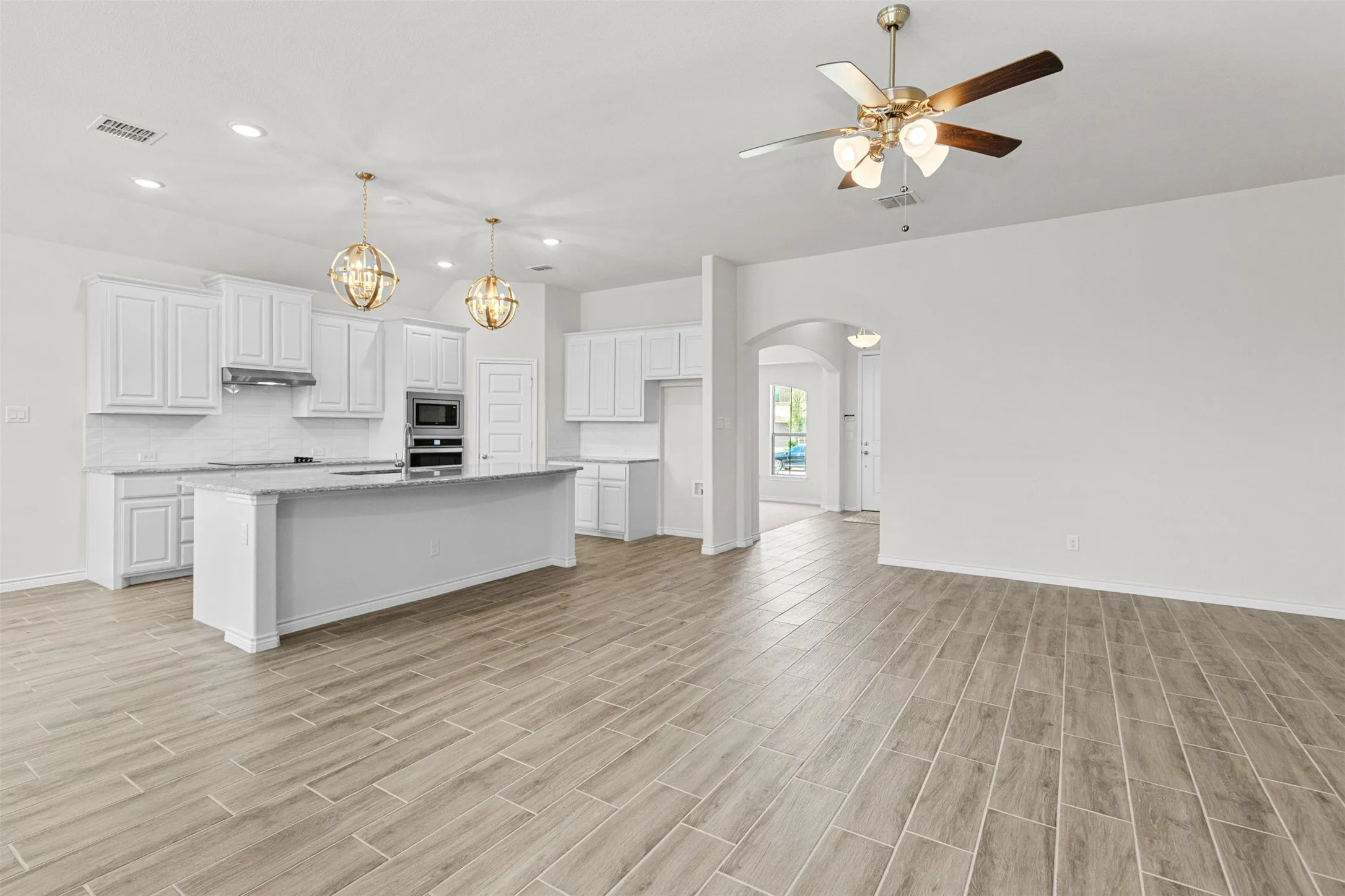 Open-concept living area featuring wood-finish flooring