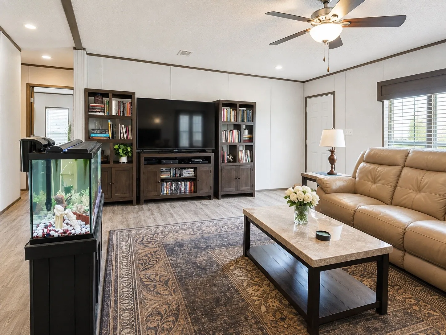 Living area featuring wood-finish flooring, recessed lighting, and a ceiling fan with integrated light