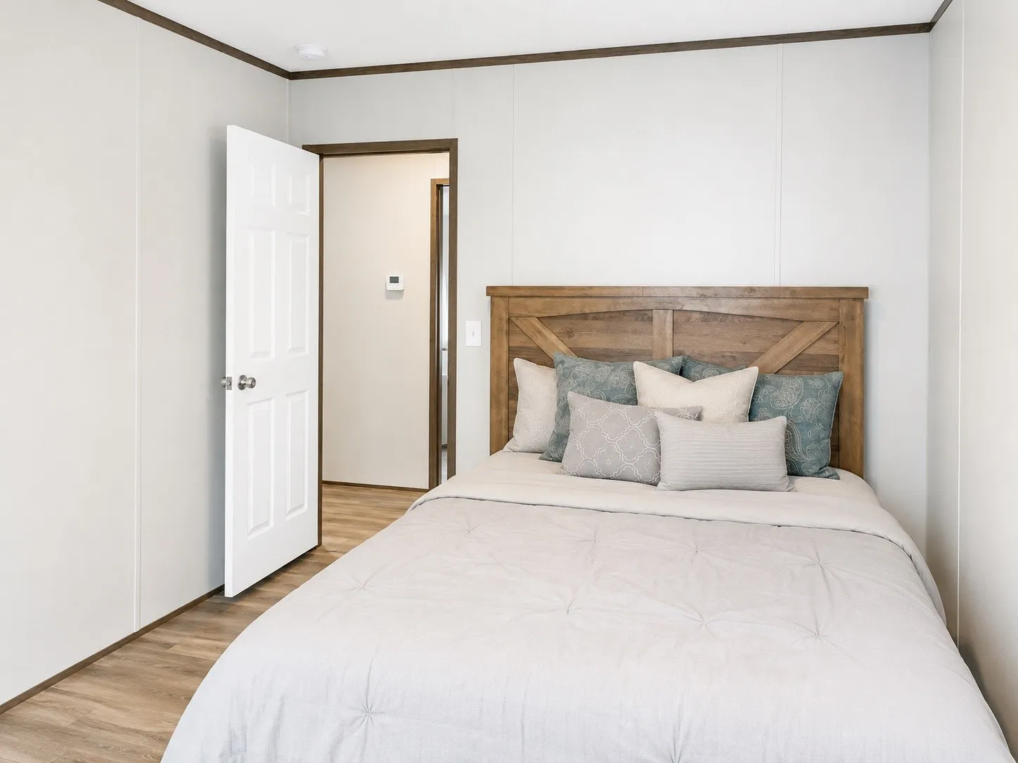 Interior room featuring wood-finish flooring, light-toned walls, and dark trim details