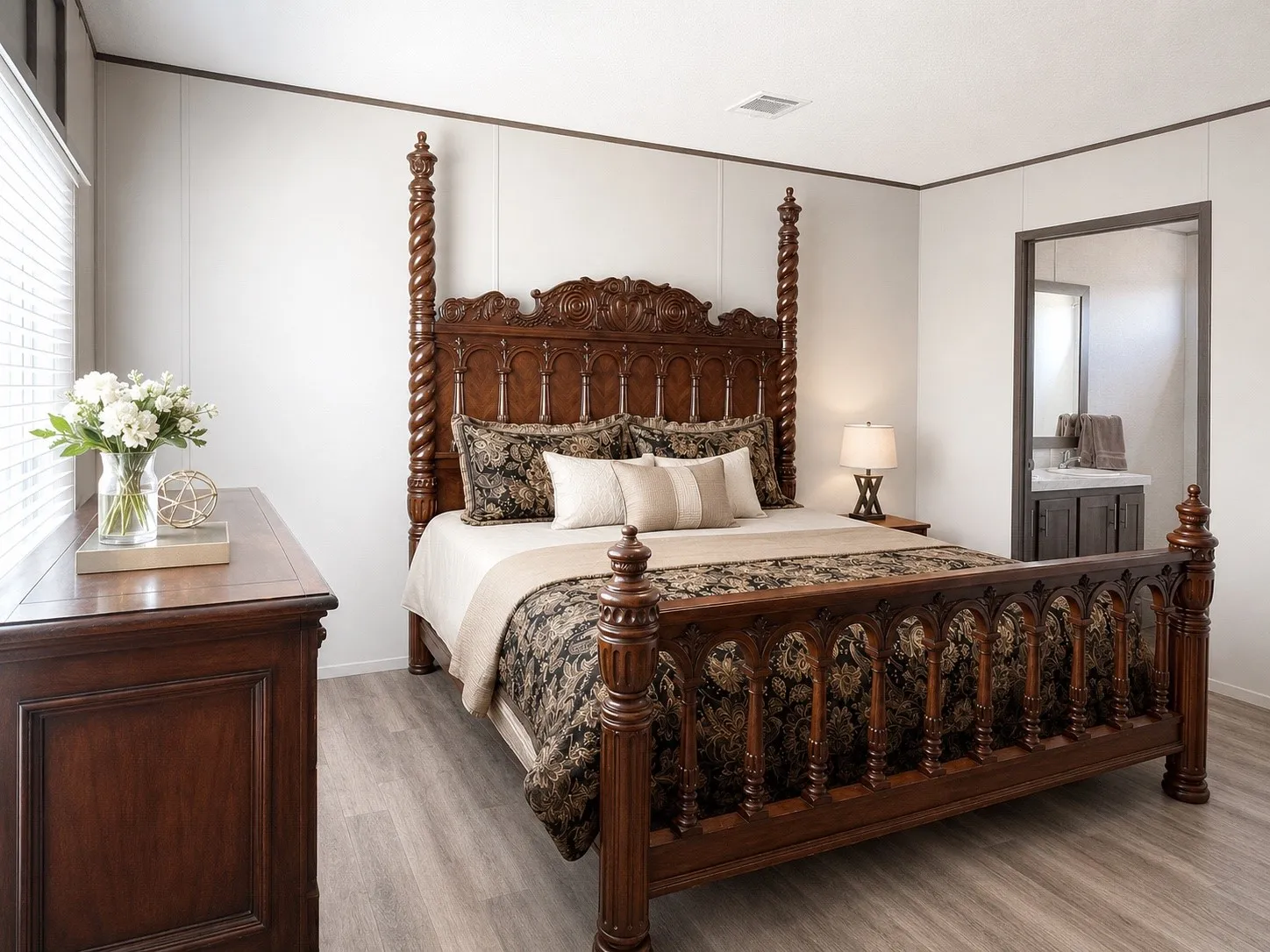 Bedroom featuring light wood-finish flooring, white paneled walls, and a window with blinds