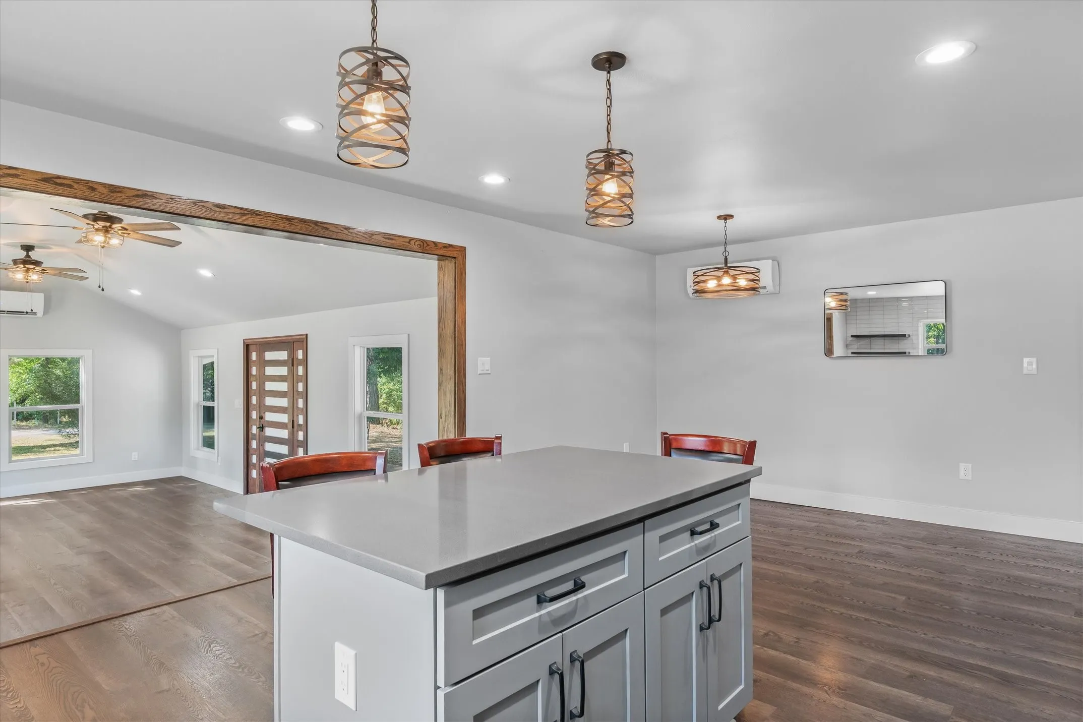 Kitchen island with gray cabinetry and light-toned countertop