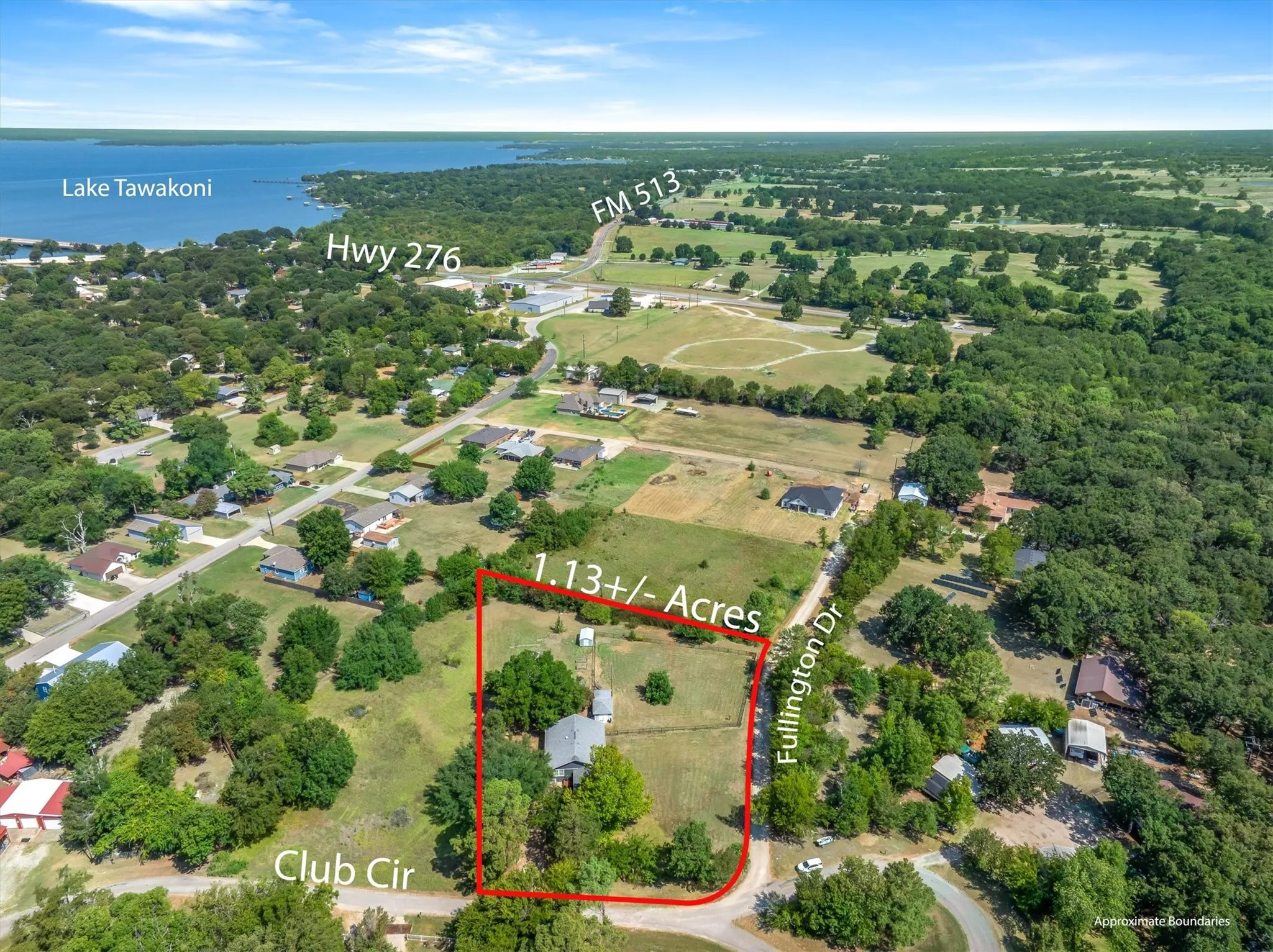 Expansive 1.13+/- acre lot featuring a residential structure, mature trees, and direct access to Fullington Drive and Club Circle