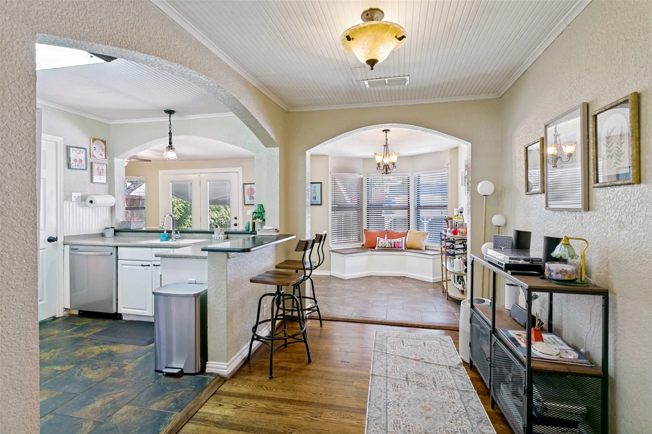 A view of the kitchen and the window seat beyond.