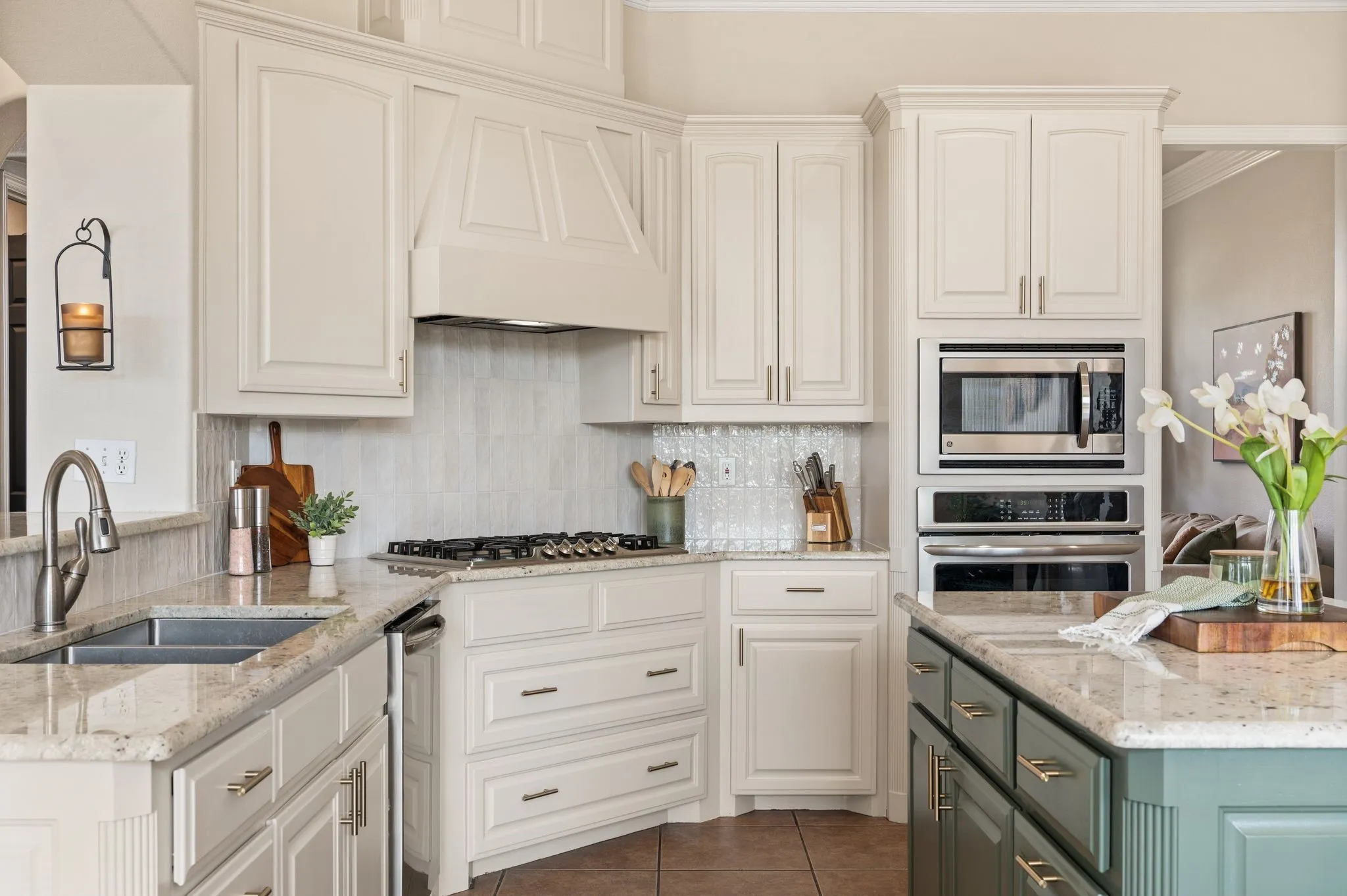 large island, peninsula seating, extensive cabinetry, double ovens, gas cooktop and a direct visual connection through the breakfast area to the backyard.