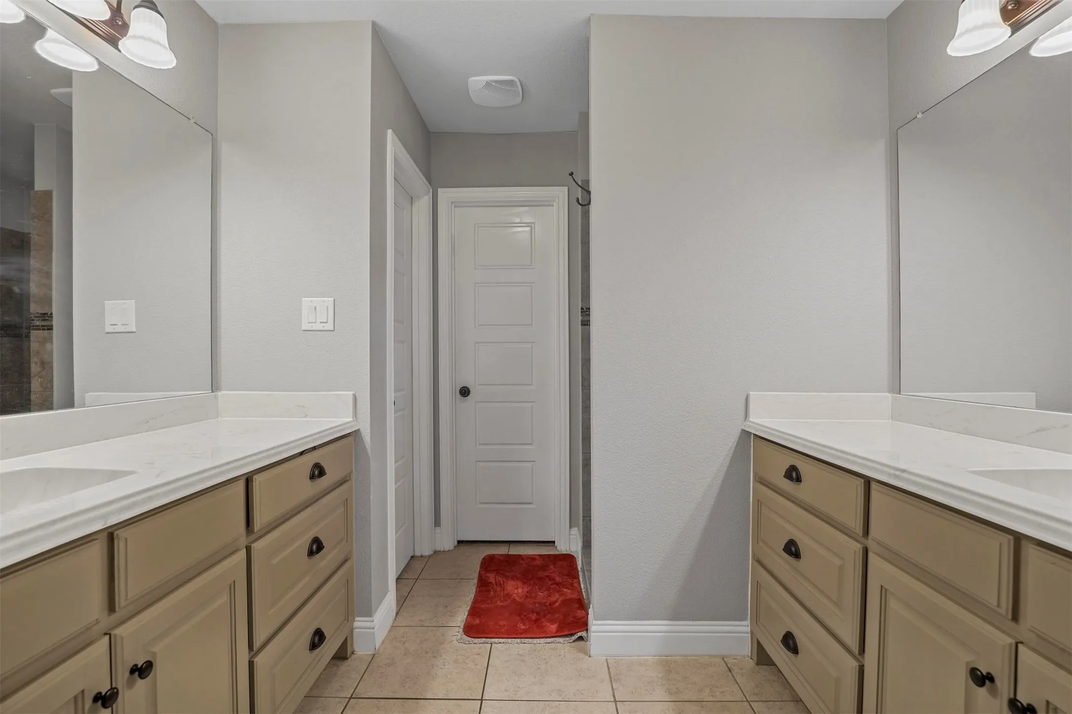 Dual vanity with integrated sinks and white countertops