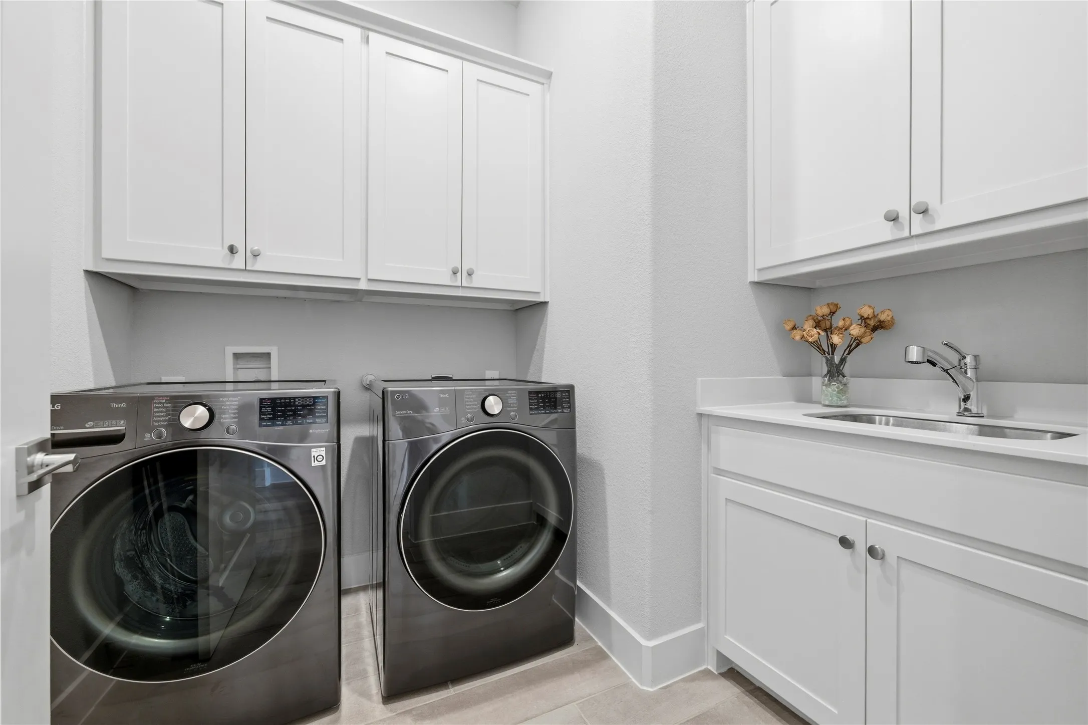 Laundry room featuring cabinet space and washing machine and clothes dryer
