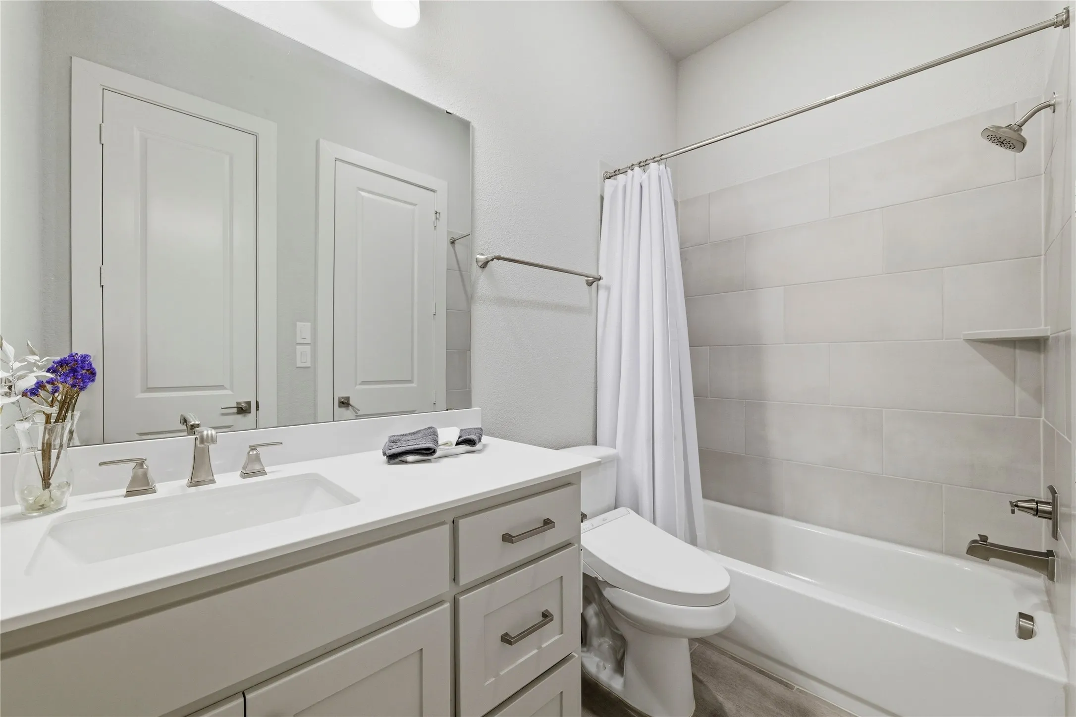Full bathroom with vanity and shower / bath combo with shower curtain