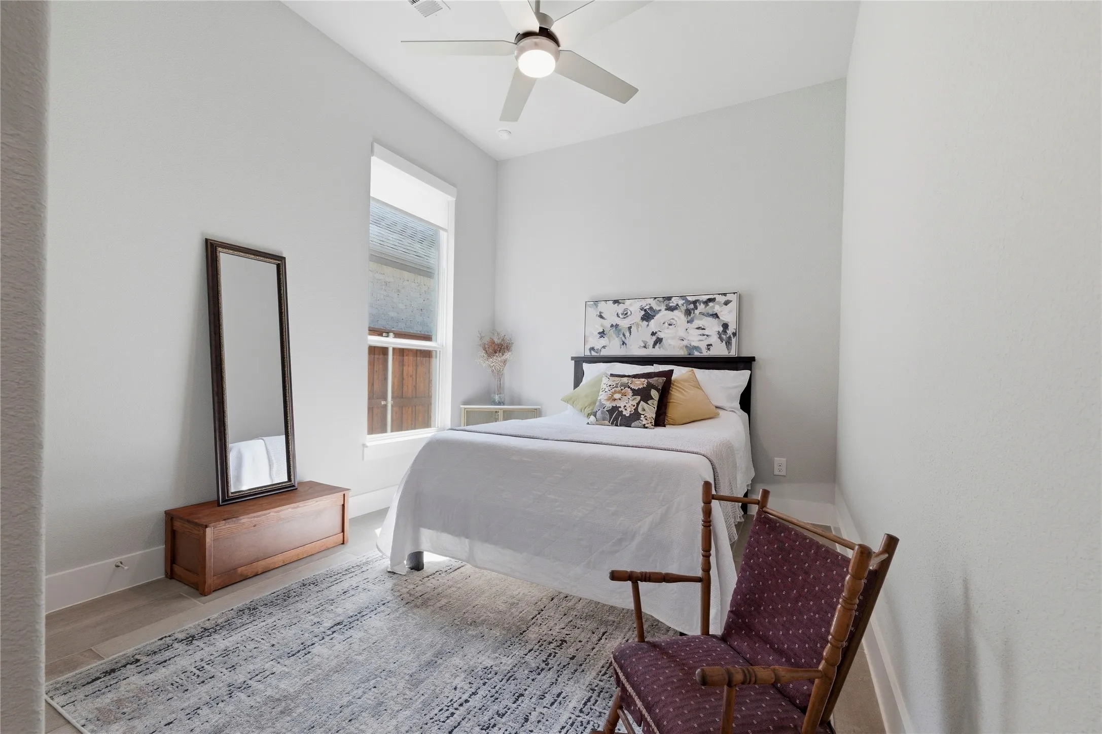 Bedroom with ceiling fan and wood finished floors