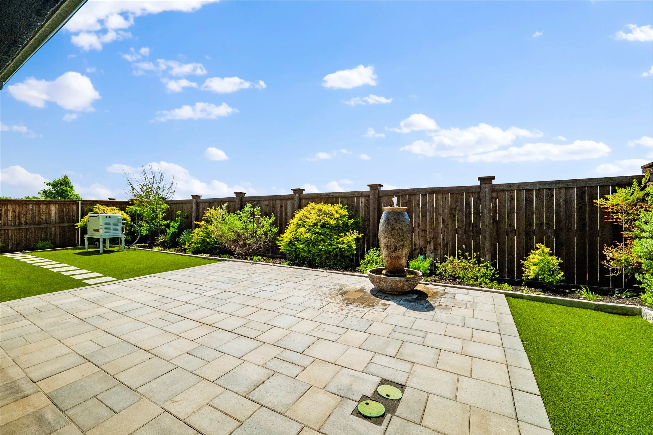 Fenced backyard with a patio