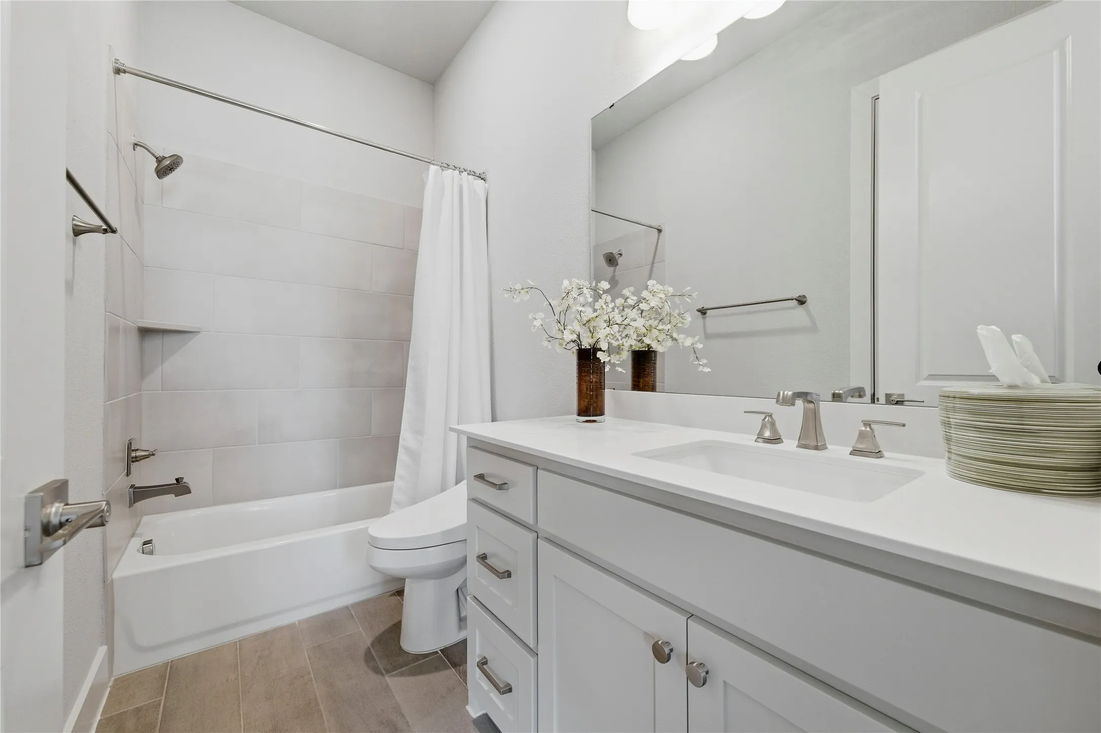 Full bath featuring vanity, shower / bath combo, and wood tiled floors