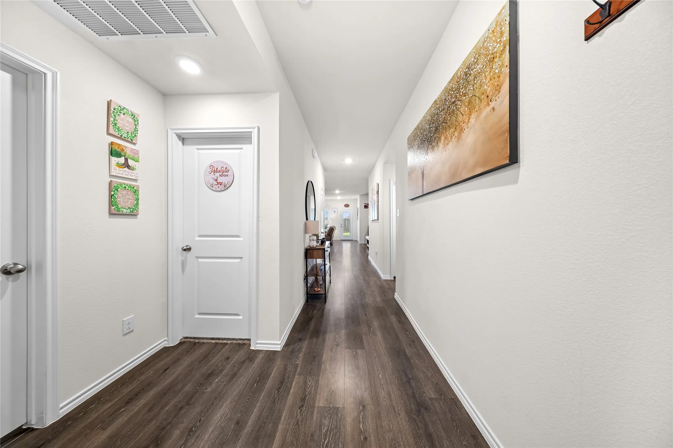 Hallway featuring wood-finish flooring, recessed lighting, white walls, white trim, and white paneled doors