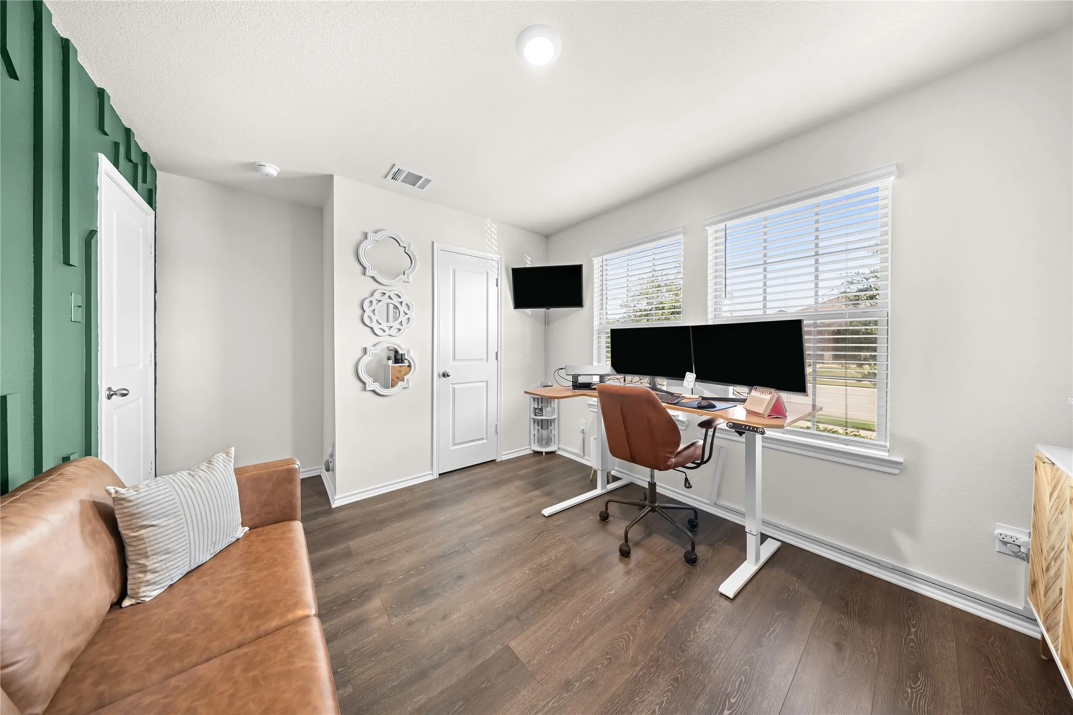 Versatile room featuring dark wood-finish flooring and a distinctive accent wall with vertical paneling