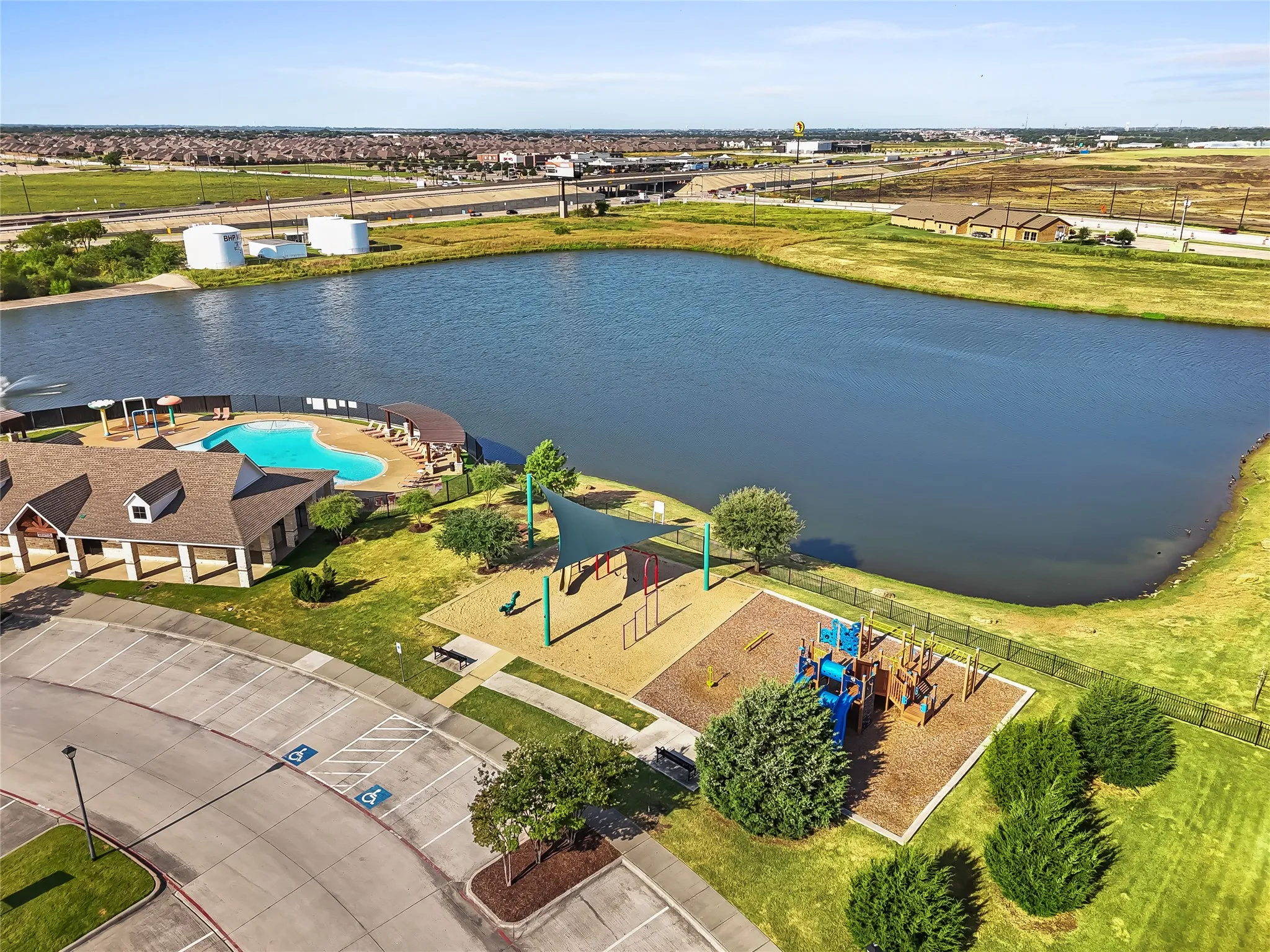 Expansive community lakefront area featuring a large, irregularly shaped body of water