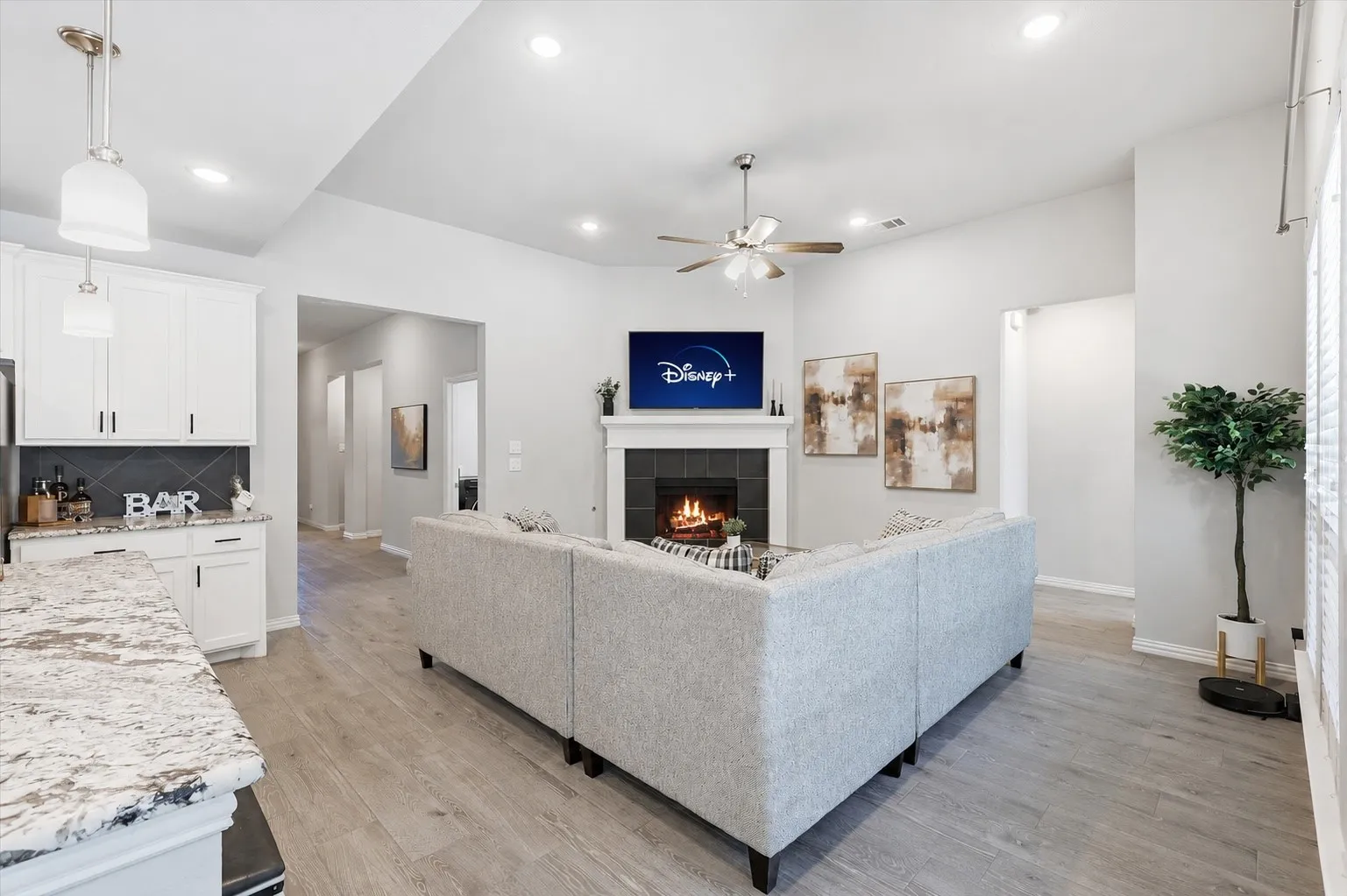 Gorgeous living room with natural light, gas fireplace, open concept to kitchen and dining and plenty of room for entertaining!